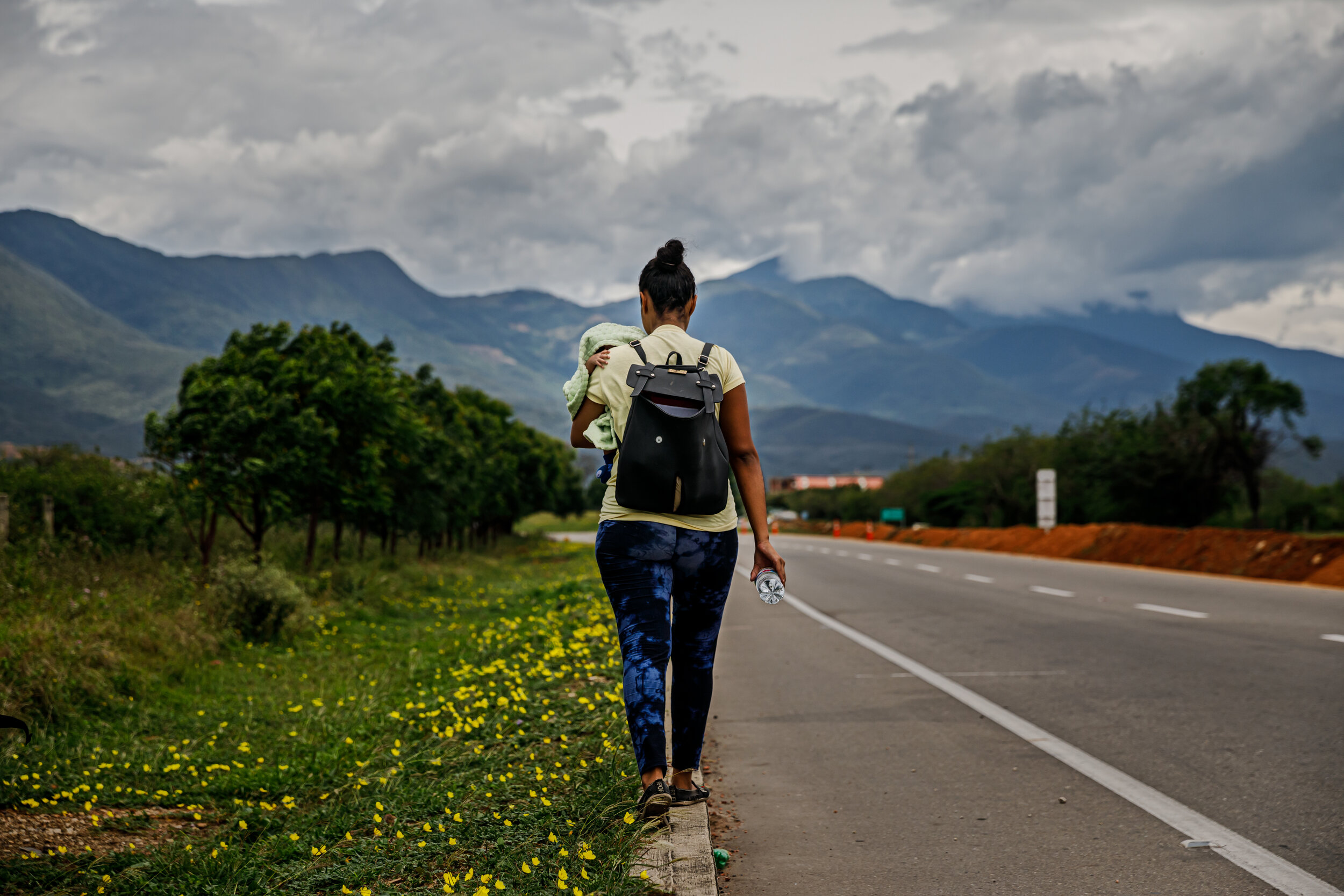  At the beginning of her journey, Valentina Durn carries her month-old son, Samuel and walks along Route 55 near Ccuta, Colombia. Nine miles from the border, Durn started feeling lightheaded. She had been diagnosed with low blood pressure and maln