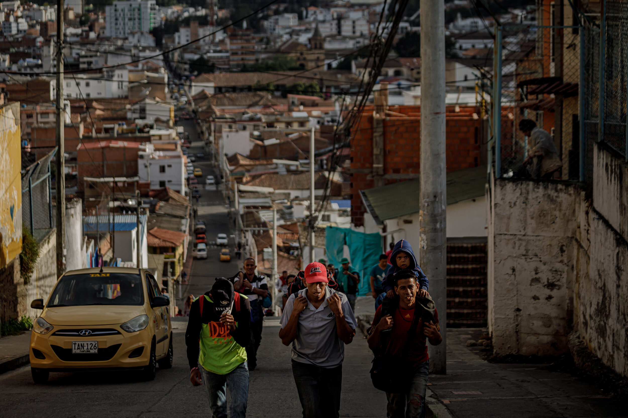  Venezuelan migrants make their way up a steep hill in Pamplona, Colombia. Each day an estimate of 5000 people flee Venezuela. They simply walk out. The most popular way out is through the Colombian border city of Ccuta. Then comes one of the most d