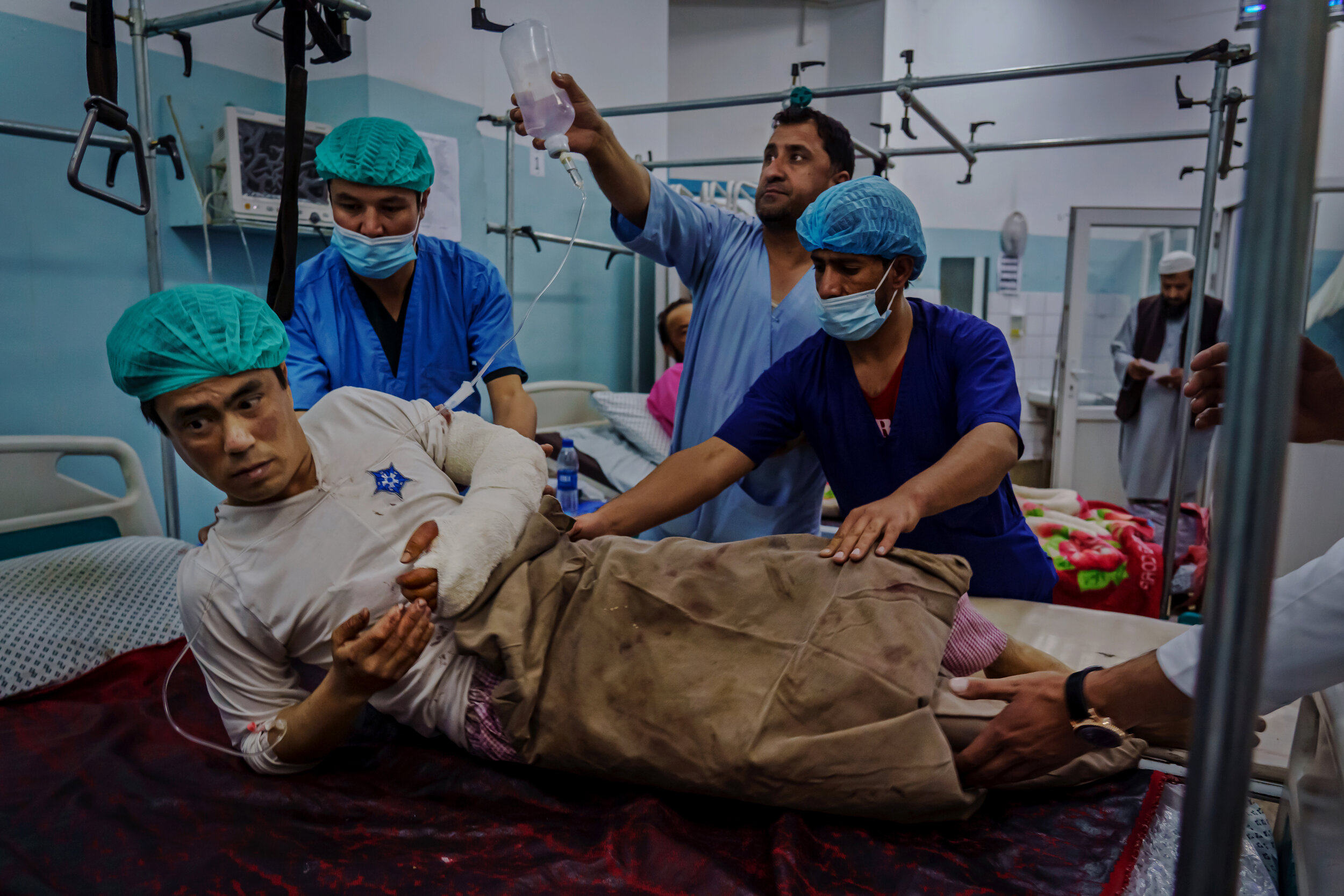  Medical staff move Mohammad Sadeqe, 33, out of the operating theater, after Sadeqe, a forensic medicine teacher was injured after an attack on Kabul University, AfghanistanÕs largest university, where three gunmen fired weapons and detonated explosi