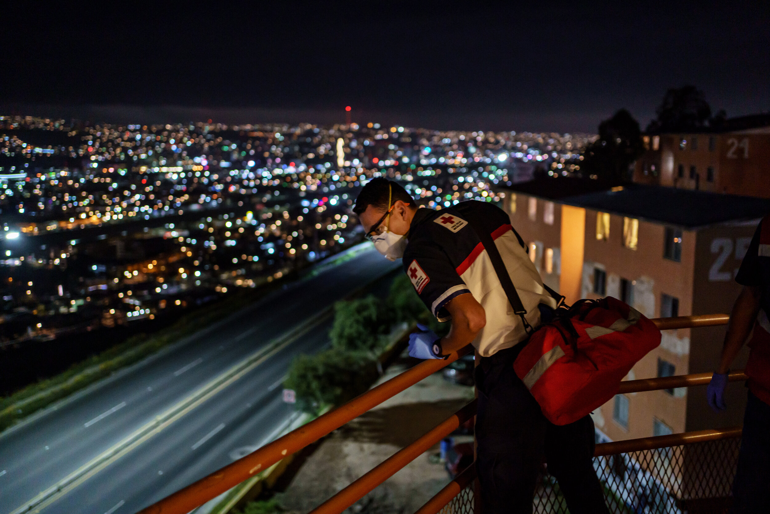  Michael Zavala, 22, a Red Cross paramedic, searches a home after they respond to a call for deceased person, but paramedics did not find any signs of a cadaver, or anyone for that matter, during an emergency call, in Tijuana, Mexico, on May 2, 2020.