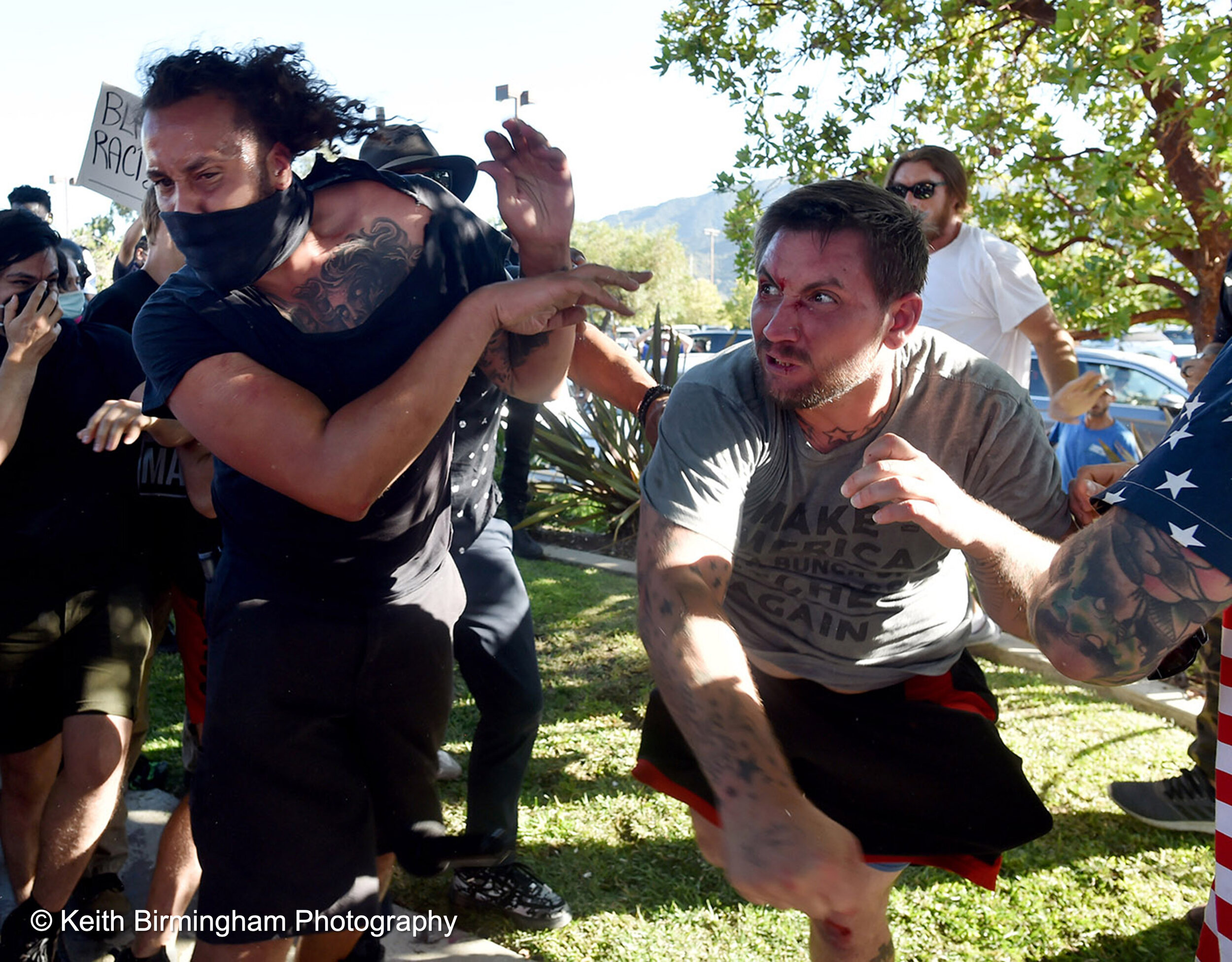  A Pro Trump supporter, right, punches a Black Lives Matter supporter during a confrontation between Black Lives Matter and Pro-Trump supporters at a rally along Foothill Blvd between the Albertsons and In-N-Out Burger in Tujunga, California on Frida
