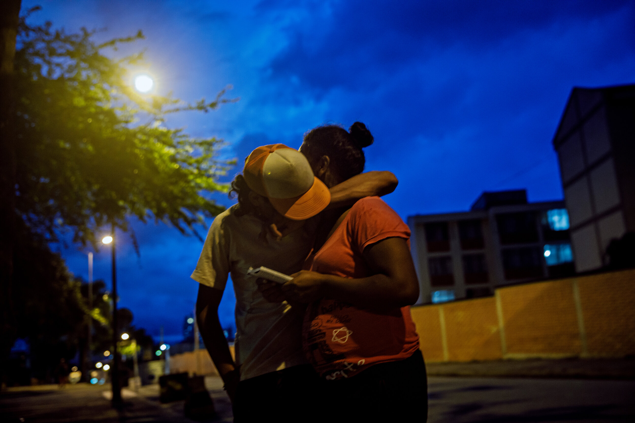  Jason Figeroa hugs his wife Herminda Flores, who is also 6 month pregnant, as they take shelter at a city park after finishing a multi-day journey on foot from Cucuta to Bucaramanga, Colombia. The couple, along with their 4-year-old son were robbed 
