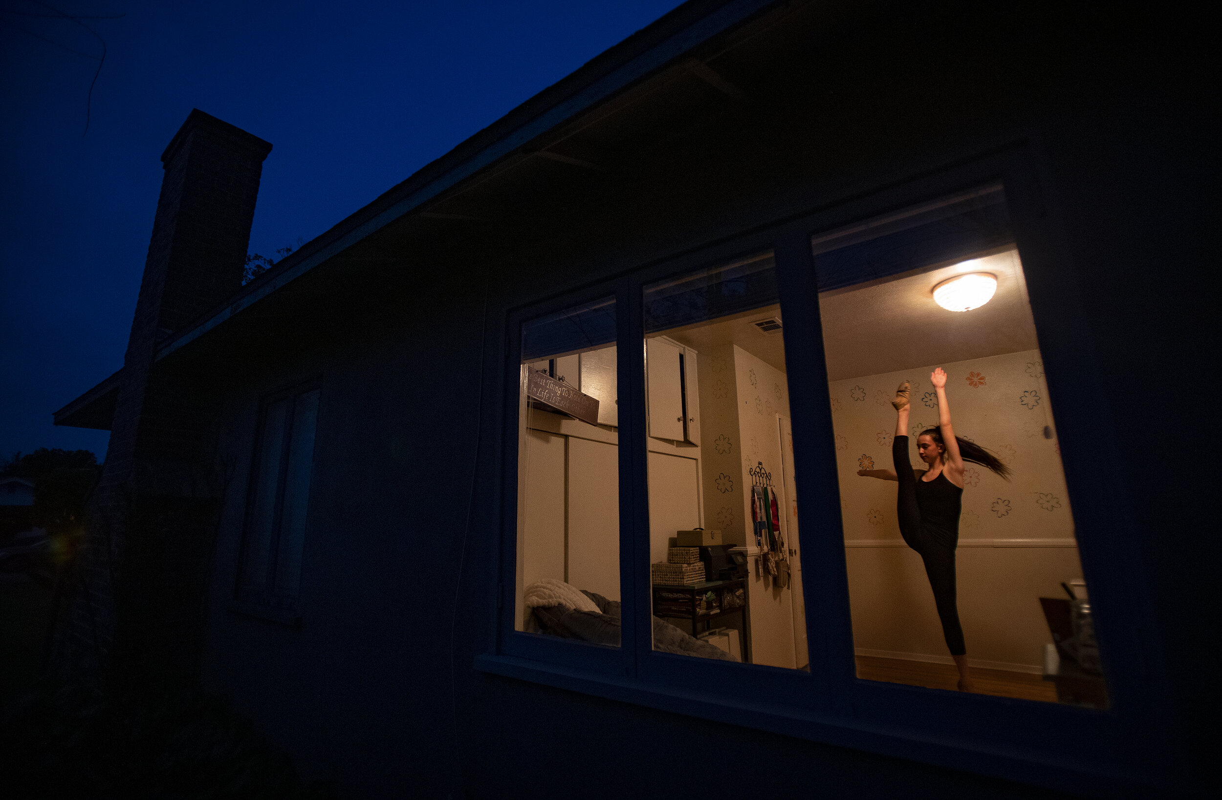  RIVERSIDE, CA - MARCH 31, 2020: Grace Carter,15 of Riverside practices her dance routine in the isolation of her bedroom since her dance classes and school were canceled during the coronavirus pandemic on March 31, 2020 in Riverside, California. On 