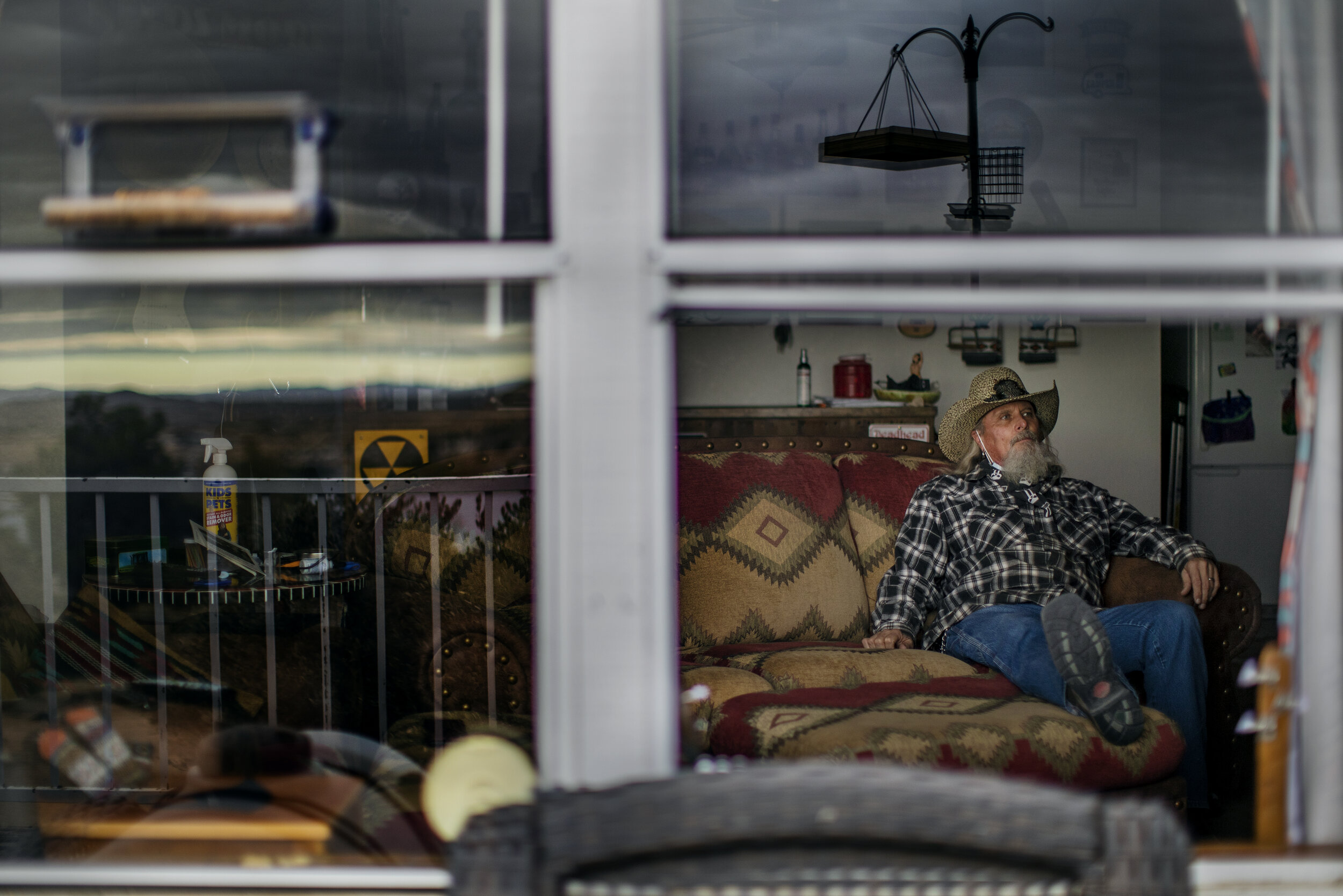  JOSHUA TREE, CA - DECEMBER 12, 2020:  Billy Folsom of Joshua Tree sits on the same spot on the couch where his wife Kim loved to sit and stare out the window at the desert scenery on December 12, 2020 in Joshua Tree, California. Kim died last week a