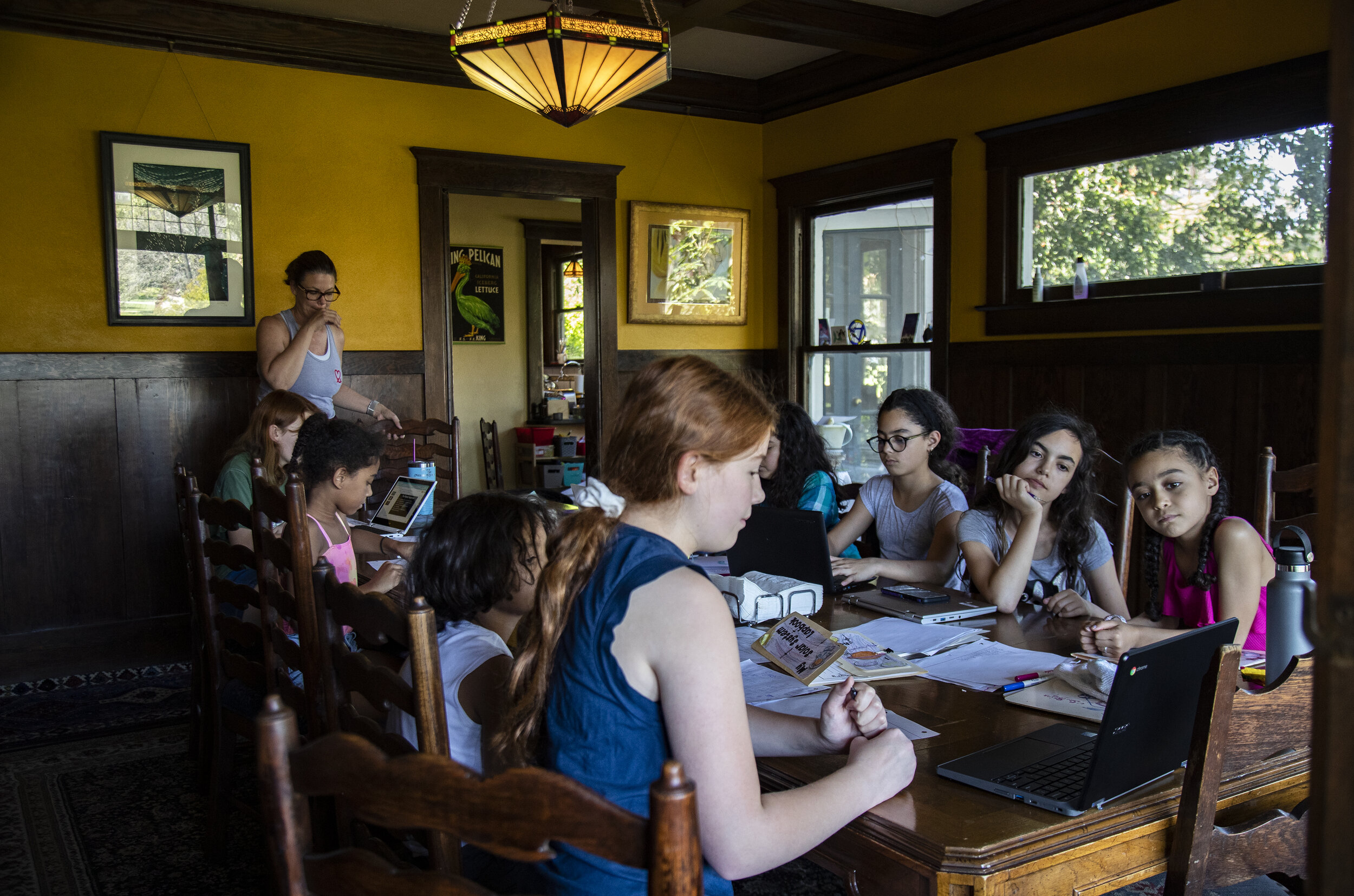  RIVERSIDE, CA- APRIL 23, 2020: Ellie Bristow, left, gives her science presentation to the class at the Roth’s dining room table home school in the midst of the coronavirus pandemic on April 23, 2020 in Riverside, California. The Bristow’s, Roth’s an
