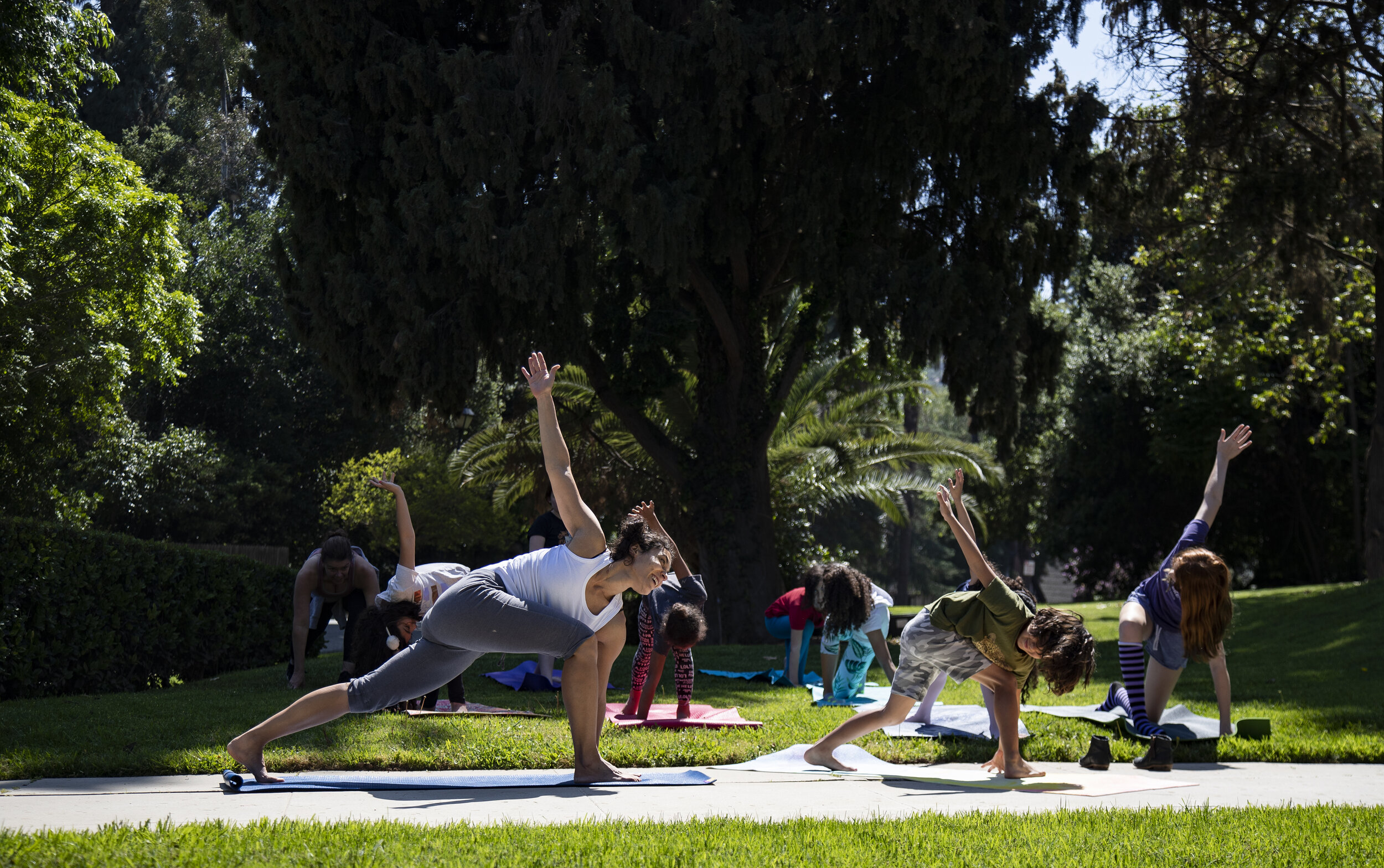  RIVERSIDE, CA- APRIL 21, 2020: Veronica Roth teaches yoga PE class in the front yard during home school in the midst of the coronavirus pandemic on April 21, 2020 in Riverside, California. The Bristow’s, Roth’s and Furbush’s, who are also neighbors,