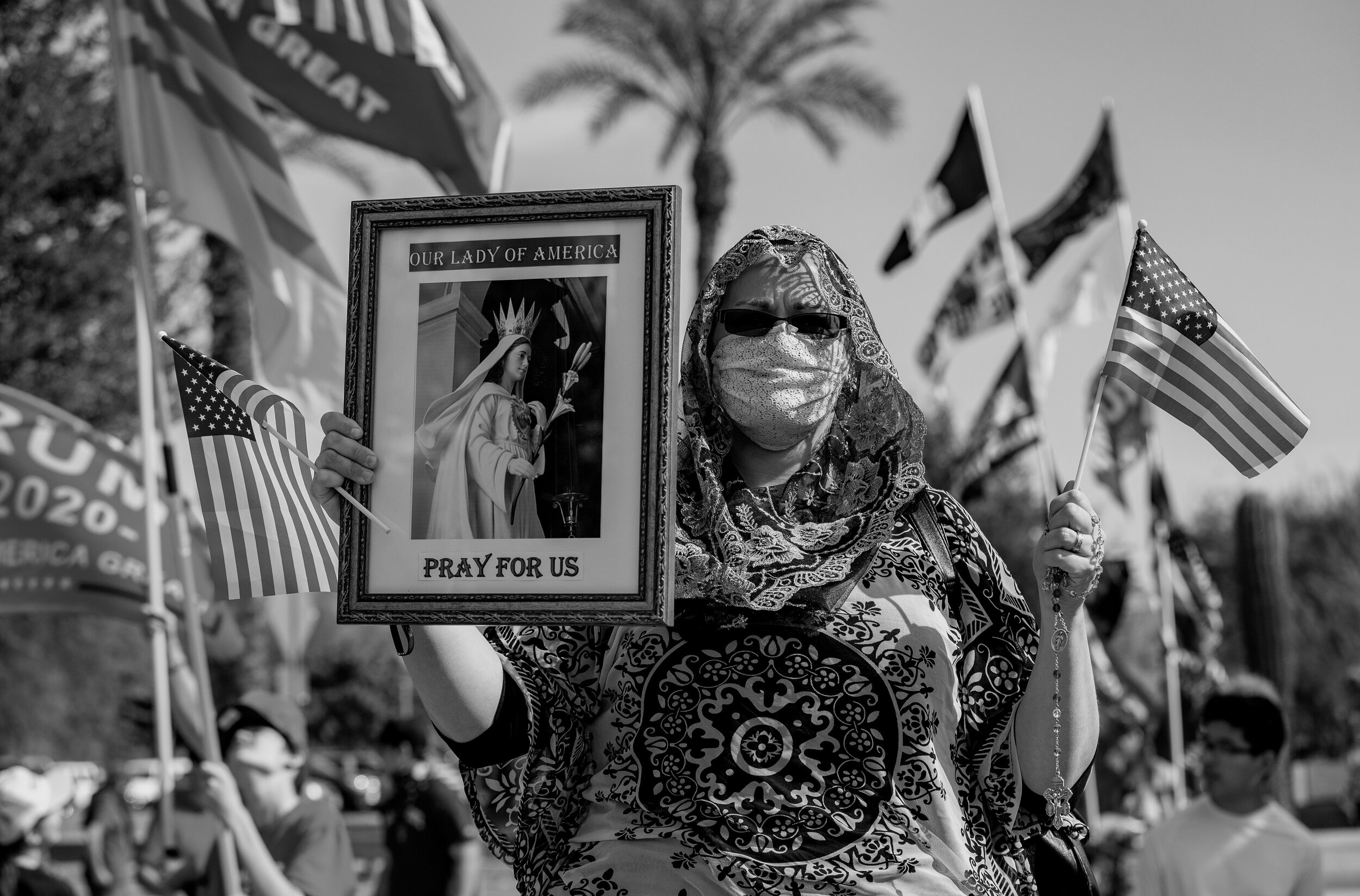  PHOENIX, AZ - NOVEMBER 7, 2020:  Trump supporter Elizabeth Lund of Gilbert holds her rosary and a religious photo while attending a “Stop The Steal” rally  on the same day Biden was named President-elect  on November 7, 2020 at the State Capitol in 