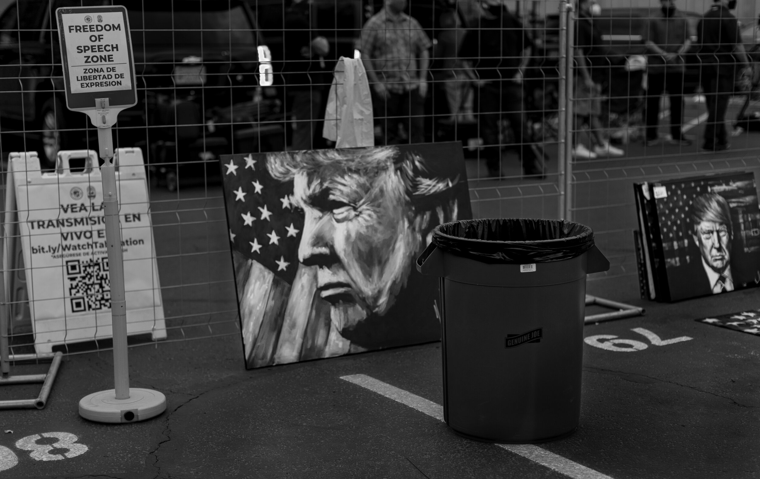  PHOENIX, AZ - NOVEMBER 6, 2020:  Paintings of President Trump lean against a fence near a trash can the day before Joe Biden was named President- elect in the parking lot at the Maricopa  County Tabulation and Election Center where day long rallies 