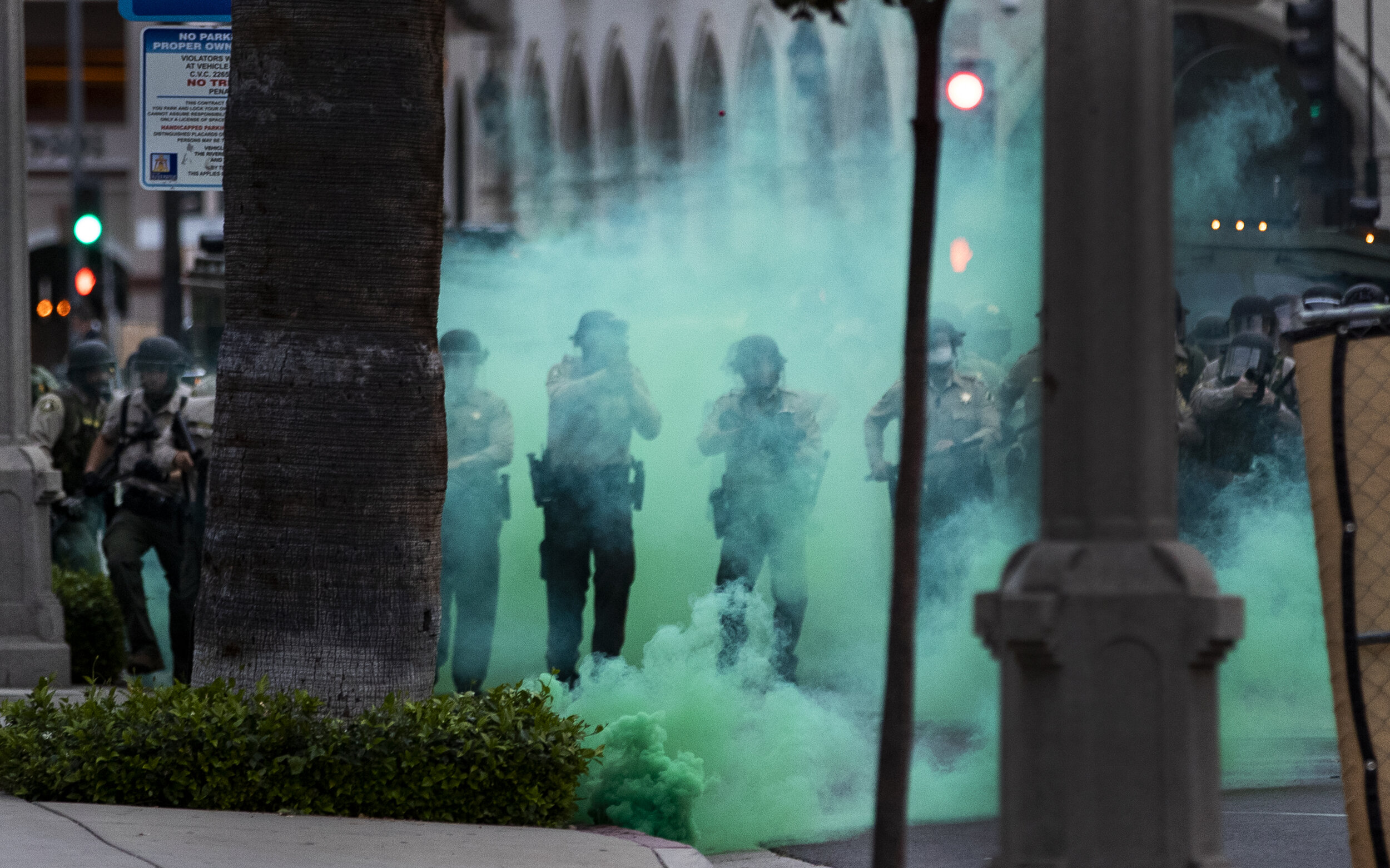  RIVERSIDE, CA - JUNE 1, 2020: Riverside County Sheriffs fire tear gas towards protesters after they moved a fence into the street during the coronavirus pandemic on June 1, 2020 in Riverside, California. Thousands of protesters marched through the s