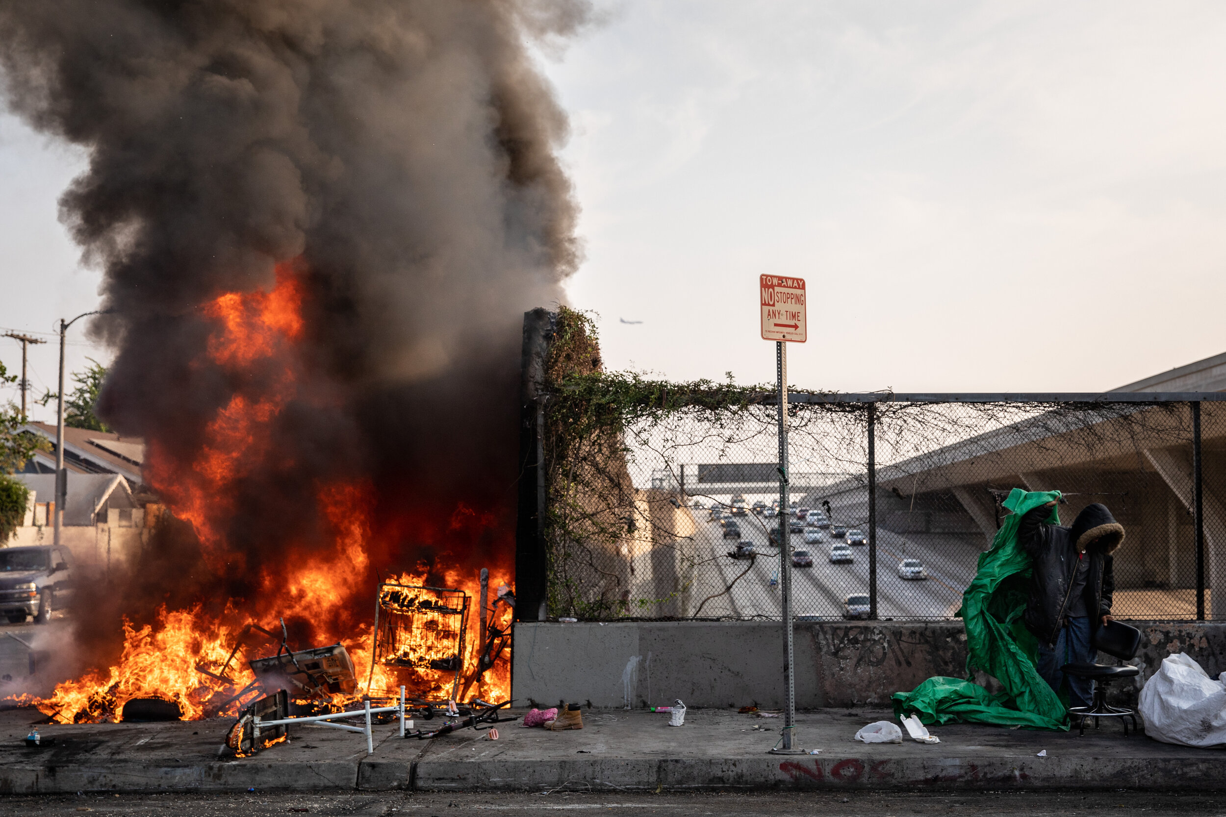  “Homeless fire” A homeless man is forced to move from his encampment at the corner of S Grand Avenue and W 54th Street, above the 110 Freeway, after another homeless encampment was engulfed in flames, in Los Angeles, CA,Thursday, Oct. 8, 2020. 