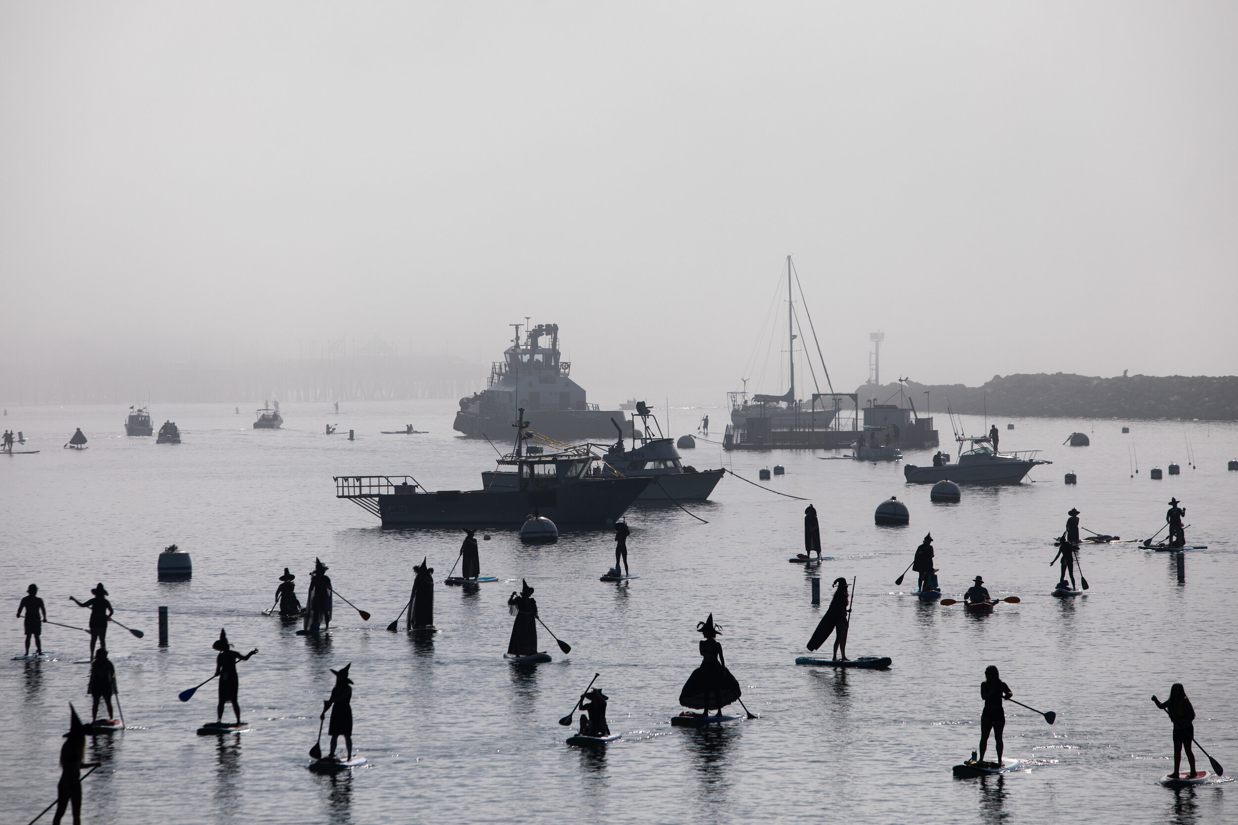  “Witch SUPers” Boats and silhouettes of dozens of witches on stand-up paddleboards make their way across King Harbor in Redondo Beach, CA, taking part in a Halloween float, sparked by a Facebook group titled, “Witches SUPers of South Bay Paddle,” Sa