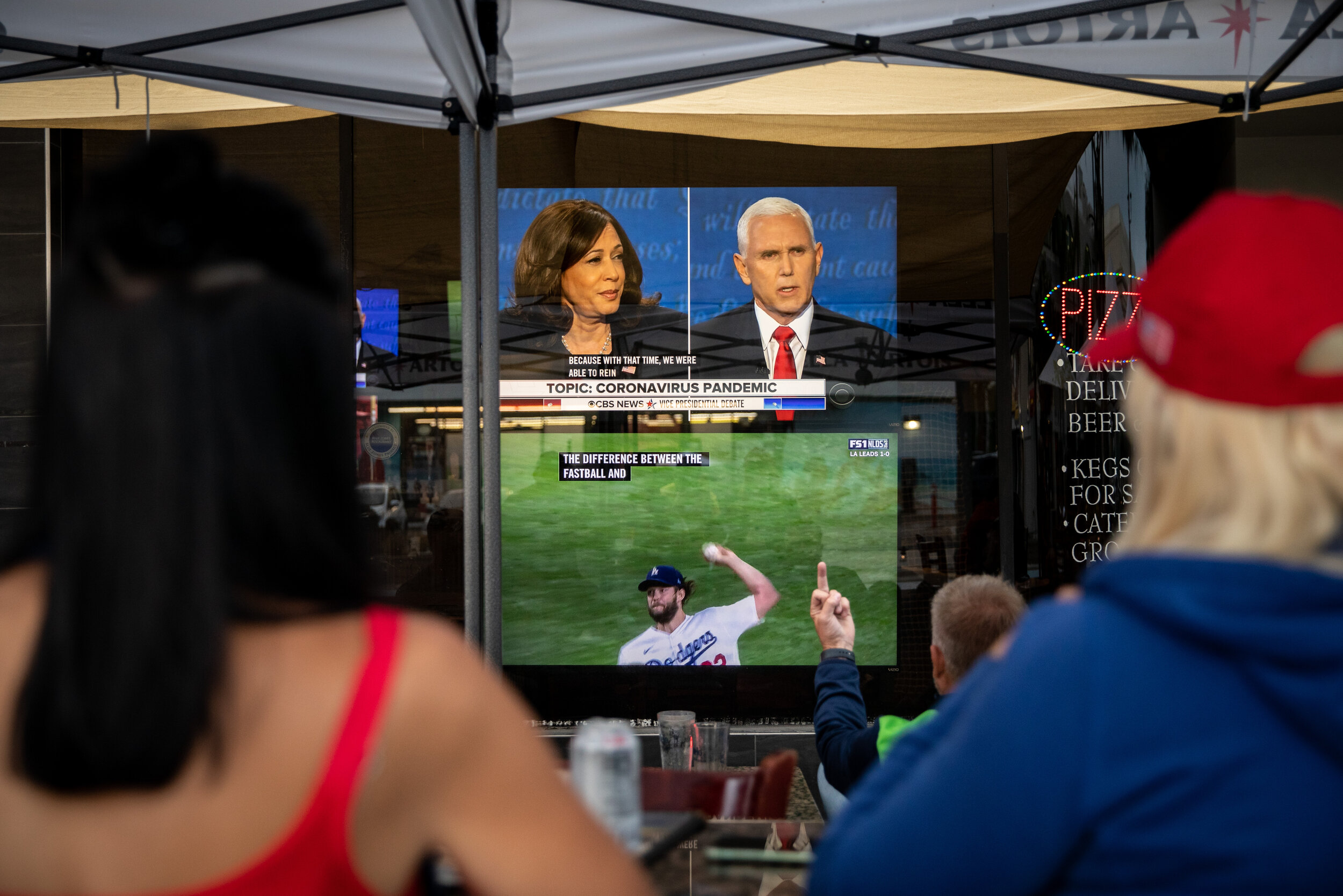 “Decisions” A man flips off the screen, while watching the Vice Presidential debate and the Dodgers and Padres National League Championship Series from outdoor seating at Pedone's Pizza, in Hermosa Beach, CA,Wednesday, Oct. 7, 2020. Dodgers pitcher 