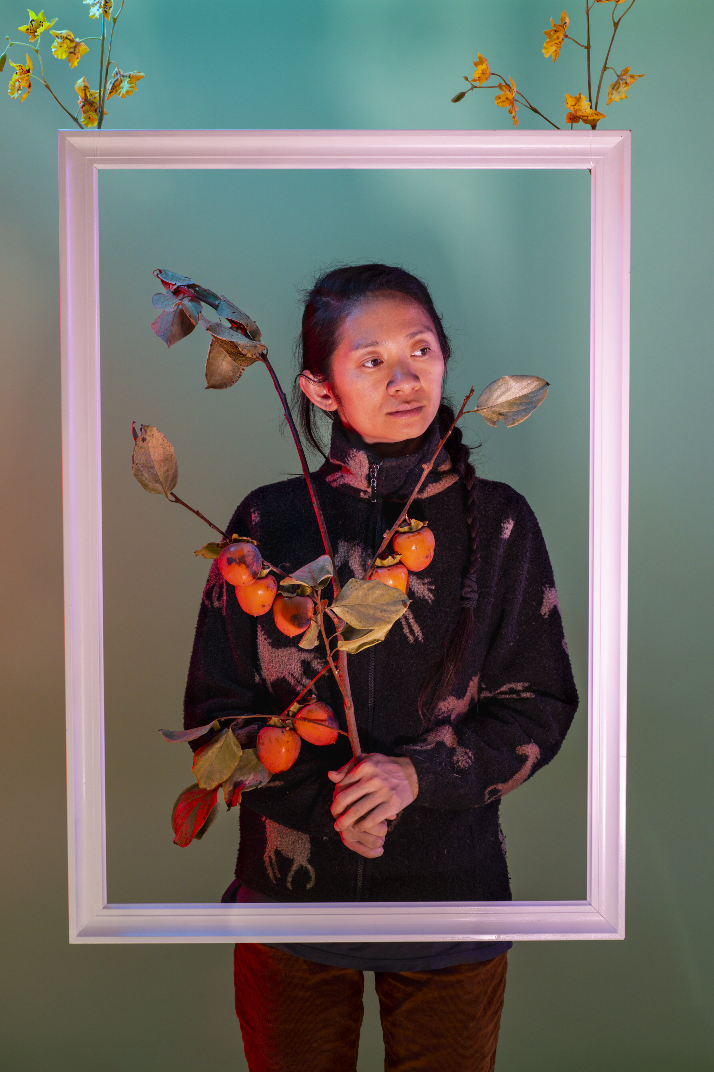  Director Chloé Zhao, holding a branch from her persimmon tree, is photographed in promotion of her film, “Nomadland,” in the backyard of her home, outside Los Angeles, CA, Friday, Nov. 13, 2020. Zhao’s second movie, Marvel’s “The Eternals,” was also