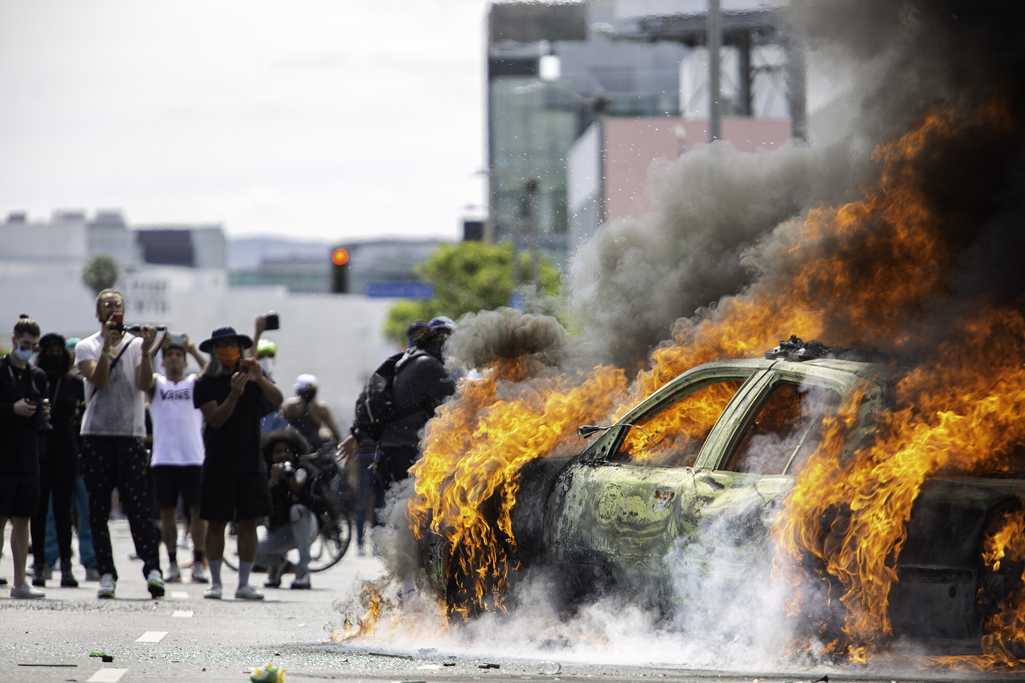  Protesters watch a police car burn on Saturday, May 30, 2020, in Los Angeles, Calif. The killing by police of George Floyd in Minneapolis, MN on May 25, triggered nationwide protests, some of which turned violent. 