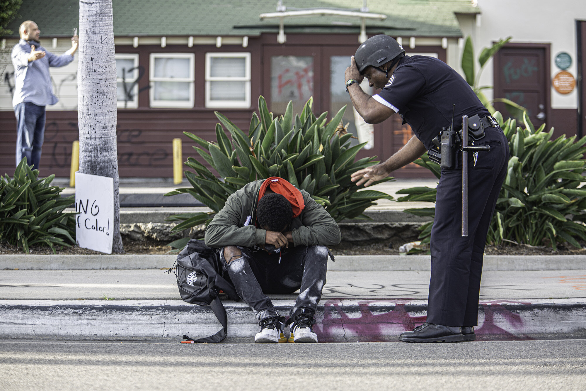  One of the protesters during the Black Lives Matter protest gets beaten by the police Friday, May 30, 2020, in Beverly hills, Calif.  