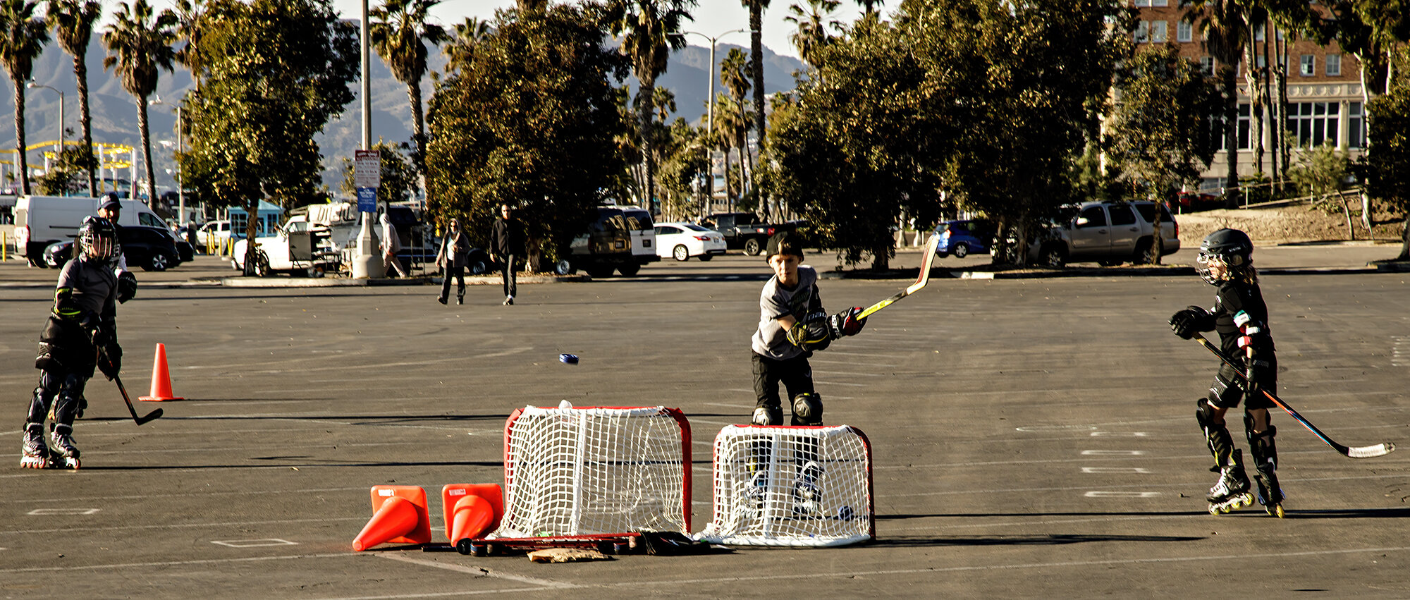  Youngsters at roller hockey practice with their coach in a beach parking lot, in Santa Monica, Calif., on Thursday, December 31, 2020. 