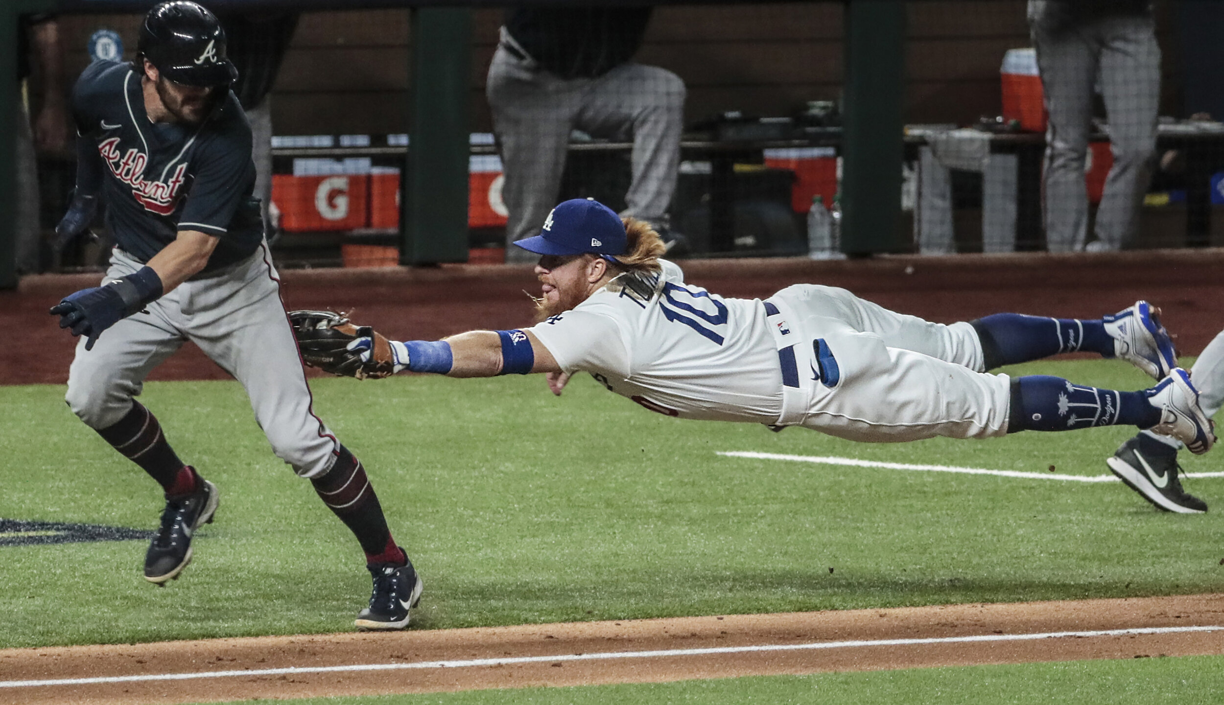  Arlington, Texas,  Sunday, October 18, 2020. Los Angeles Dodgers third baseman Justin Turner (10) tags out Atlanta Braves shortstop Dansby Swanson (7) to start double play in the fourth inning in game seven of the NLCS at Globe Life Field. 
