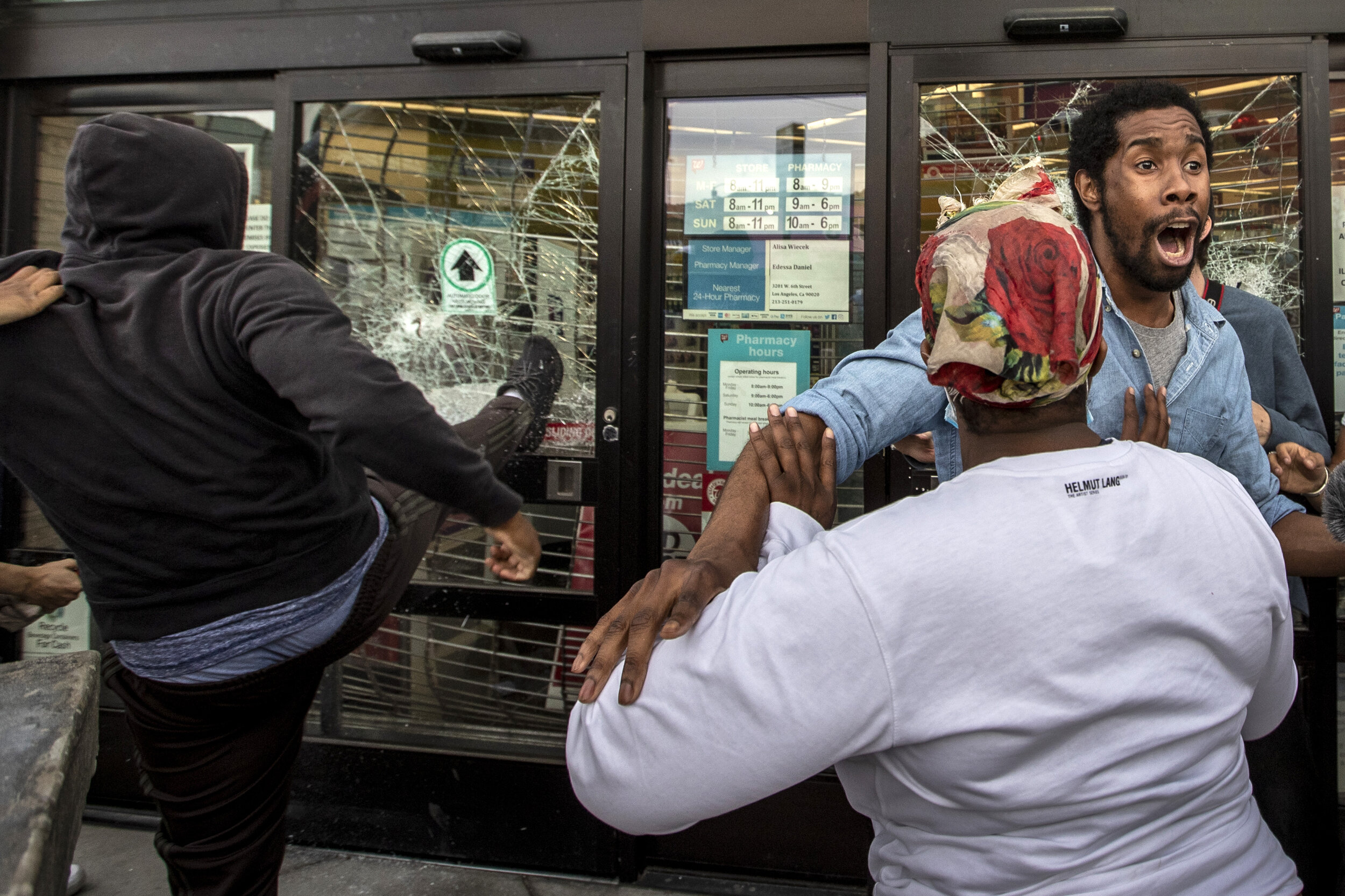  AJ Lovelace tries to stop looters from breaking into a Walgreens store at Santa Monica and Highland.  “We need peace and we need someone to talk to each other,” he said after the looters fled the scene. He was one of hundreds of protestors on June 1