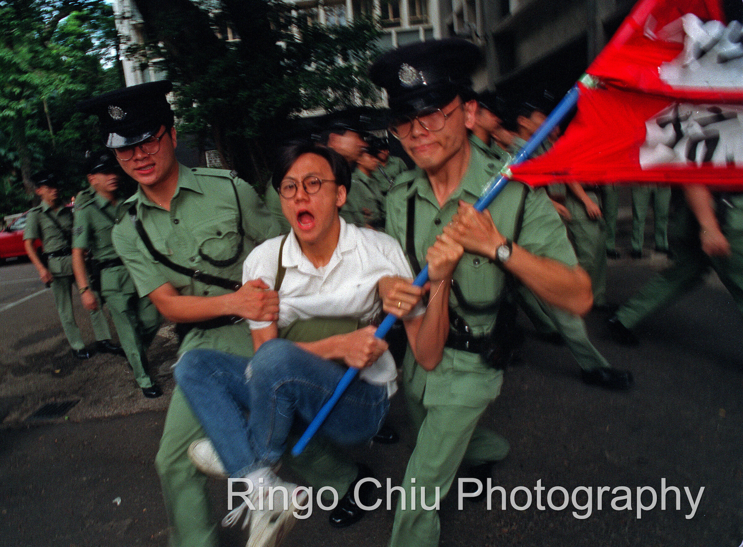  Hong Kong police officers carry a protestor during a student sit in protest blocking the entrance of the government building in Hong Kong. (1992) 
