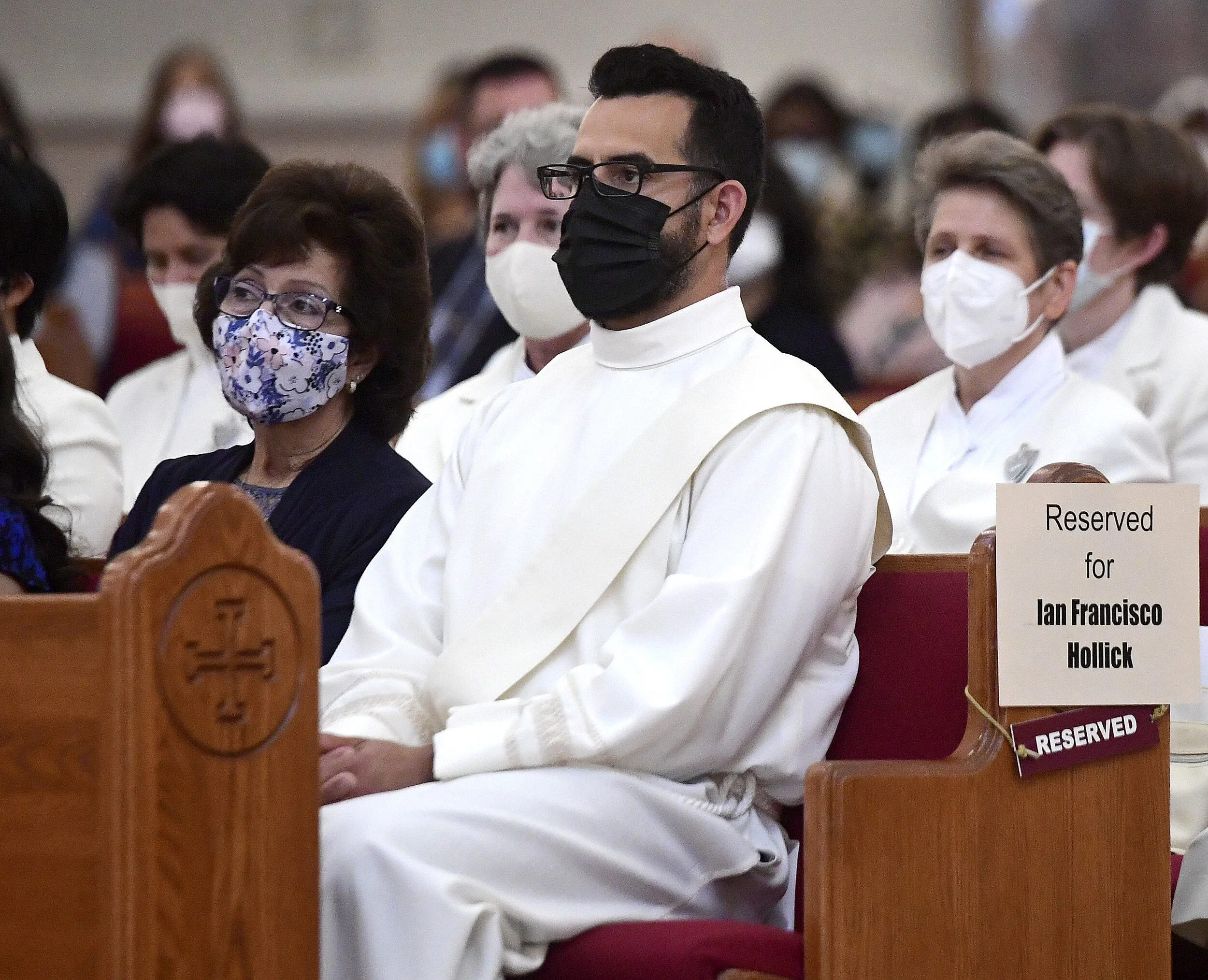  Deacon Ian Francisco Hollick, 34 from Corona, sits along side his mother Victoria during his Ordination to the Priesthood mass at Sacred Heart Church in Rancho Cucamonga Saturday morning May 29, 2021. Father Ian Hollick was assigned to the St. Marth