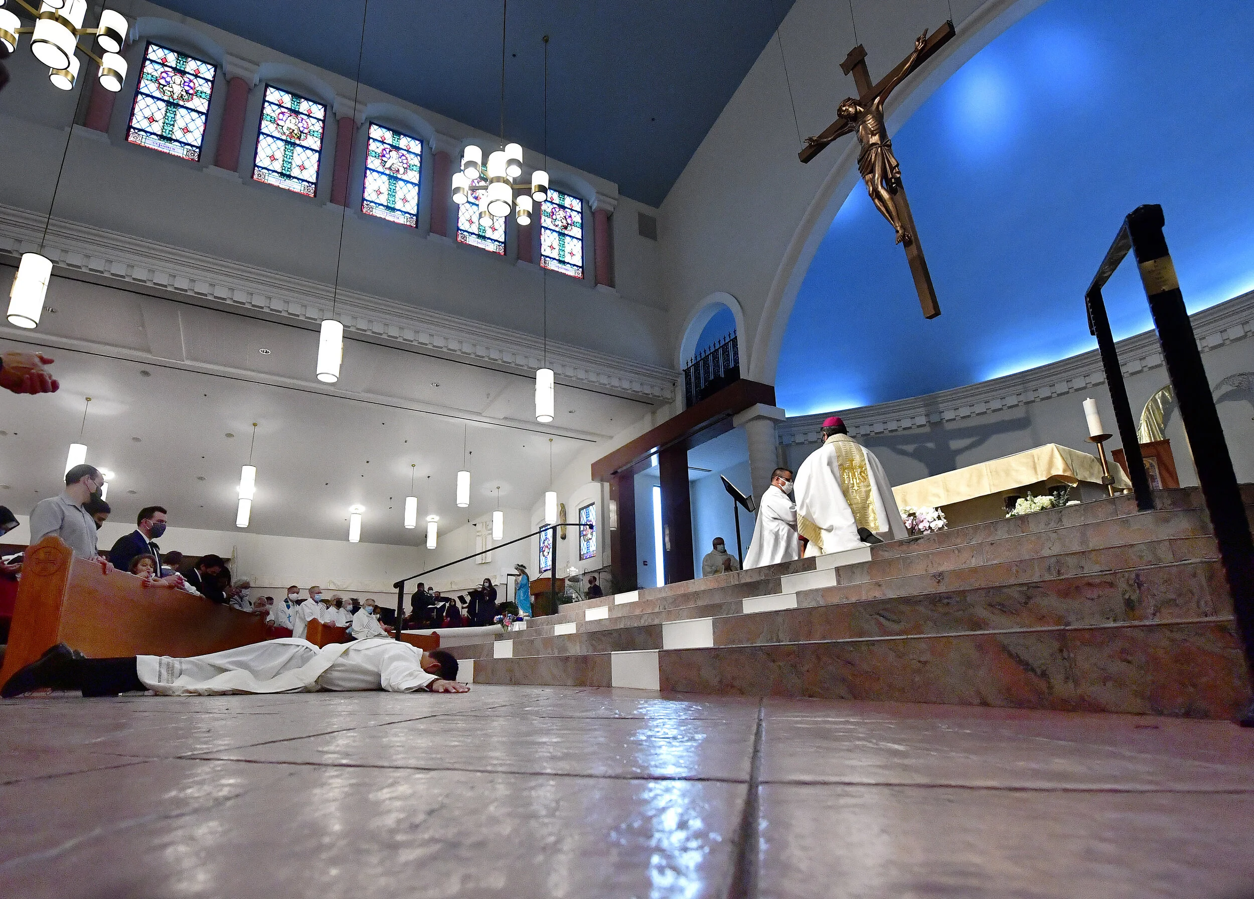  Deacon Ian Francisco Hollick, 34 from Corona, lies on the floor in the shape of the cross during the Litany of Supplication portion of his Ordination to the Priesthood mass at Sacred Heart Church in Rancho Cucamonga Saturday morning May 29, 2021. Fa
