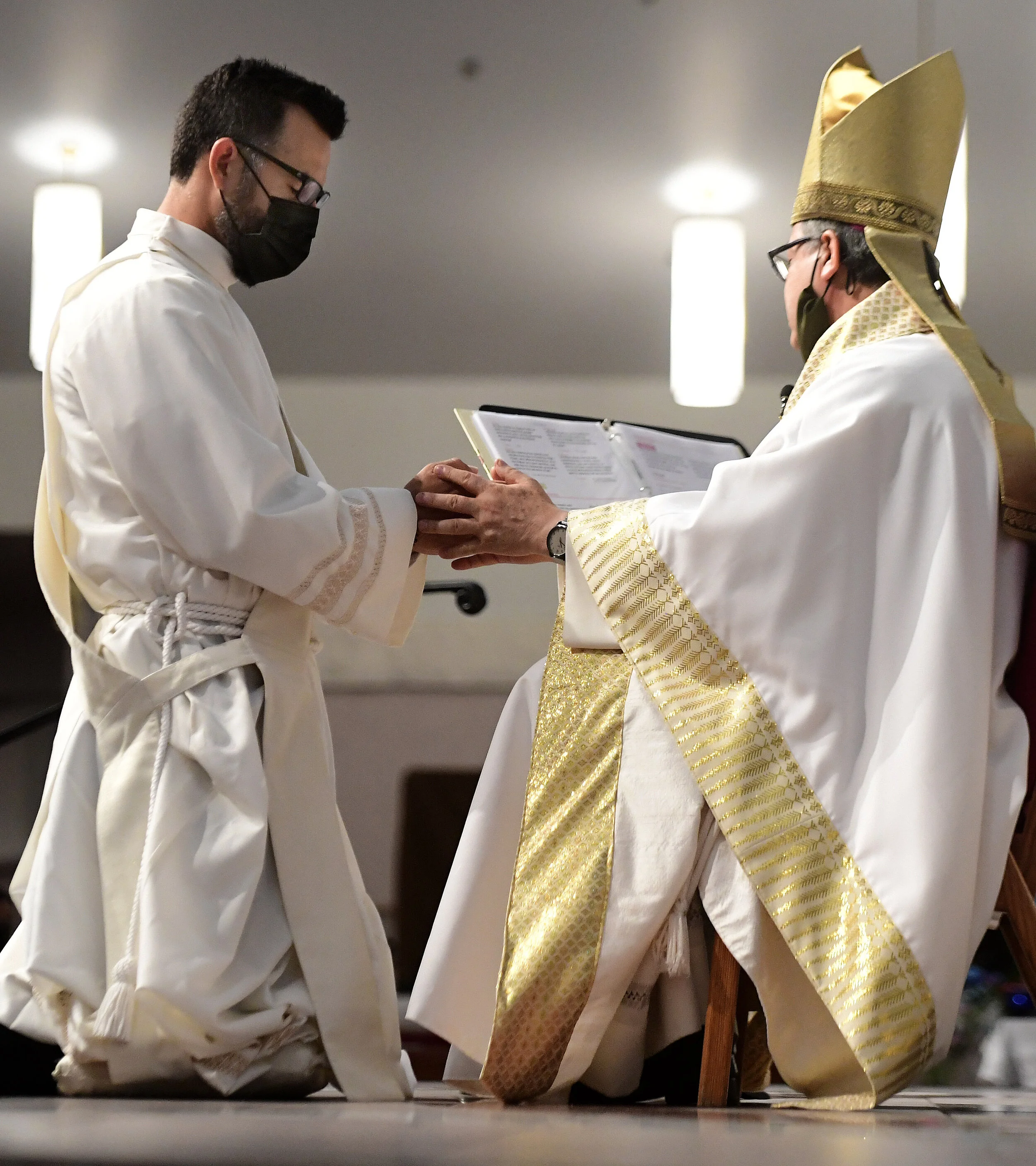  Deacon Ian Francisco Hollick, 34 from Corona, kneels before Alberto Rojas, Bishop of the Diocese of San Bernardino, during his Ordination to the Priesthood mass at Sacred Heart Church in Rancho Cucamonga Saturday morning May 29, 2021. Father Ian Hol