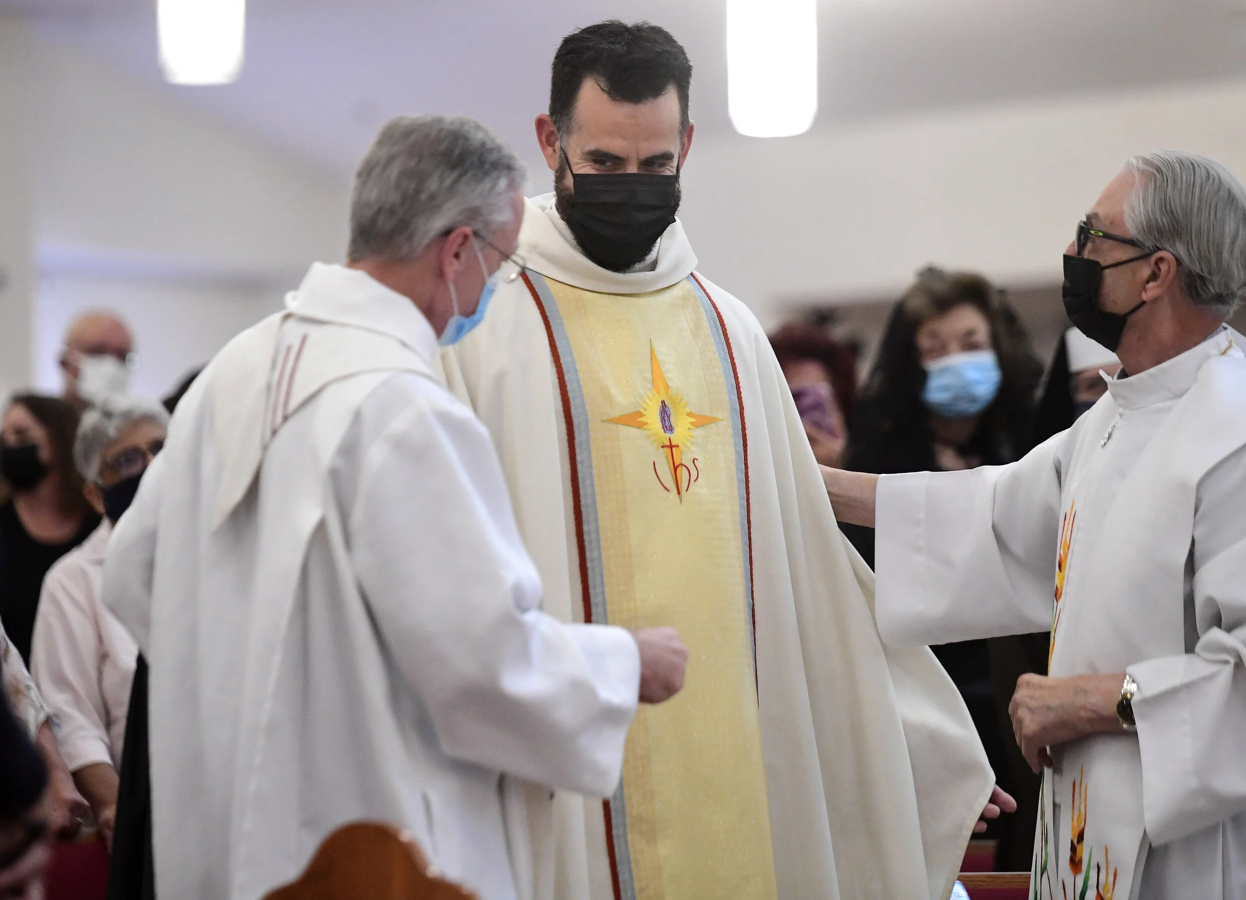  Deacon Ian Francisco Hollick (center), 34 from Corona, smiles after receiving his priesthood clothing during his Ordination to the Priesthood mass at Sacred Heart Church in Rancho Cucamonga Saturday morning May 29, 2021. Father Ian Hollick was assig