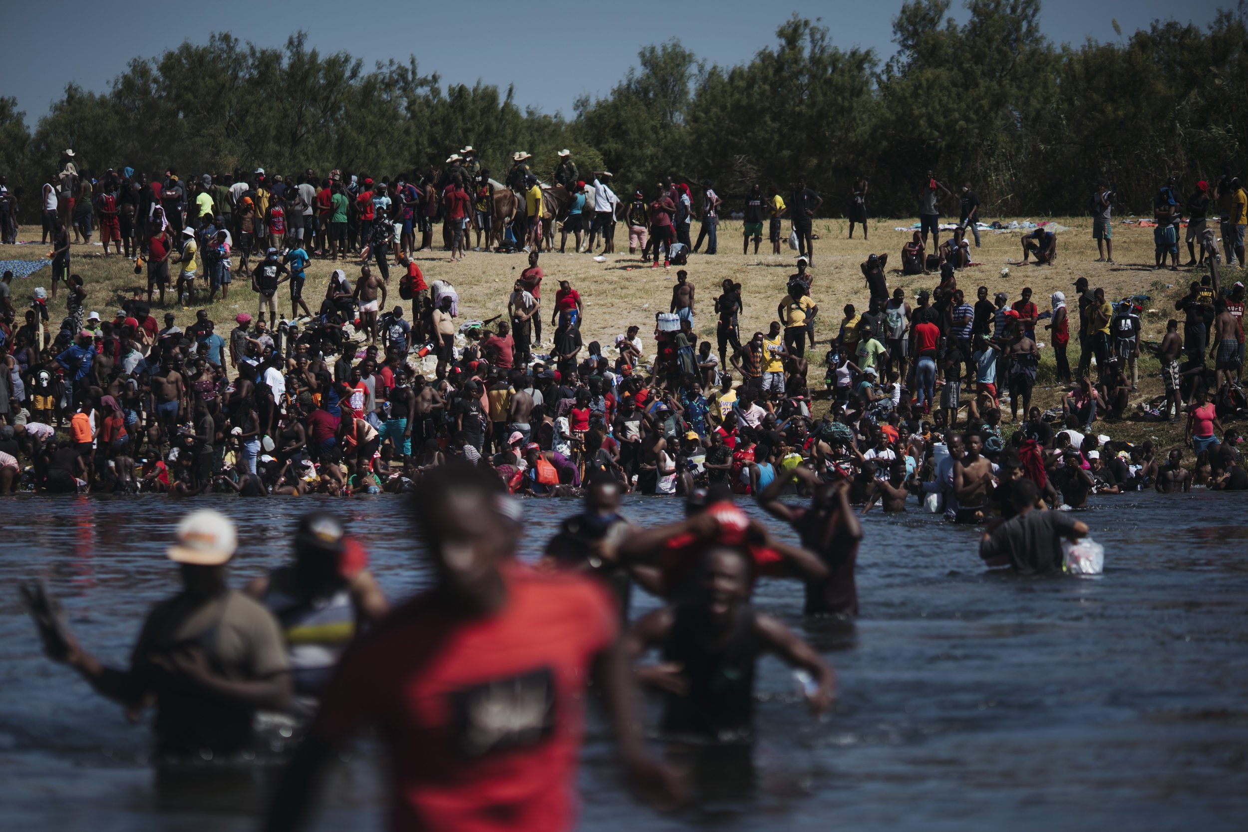 photo essay 2021 Migrants cross the Rio Grande River near the Del Rio-Acuna Port of Entry in Ciudad Acuna, Coahuila state, Mexico, on Sunday, Sept. 19, 2021.