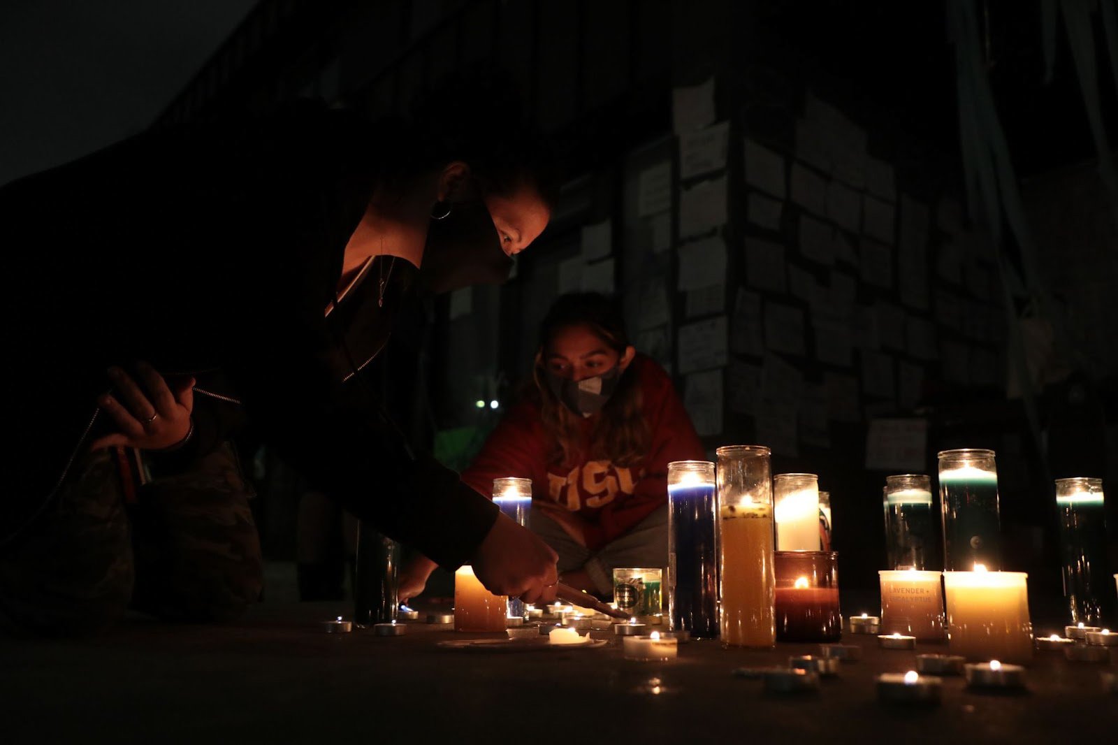  Two USC students light candles outside of the Sigma Nu fraternity house on October 22, 2021. The vigil was held for victims of sexual assualt after the Sigma Nu house was suspended for numerous reports of sexual assault at the house. (Photo by Yanni