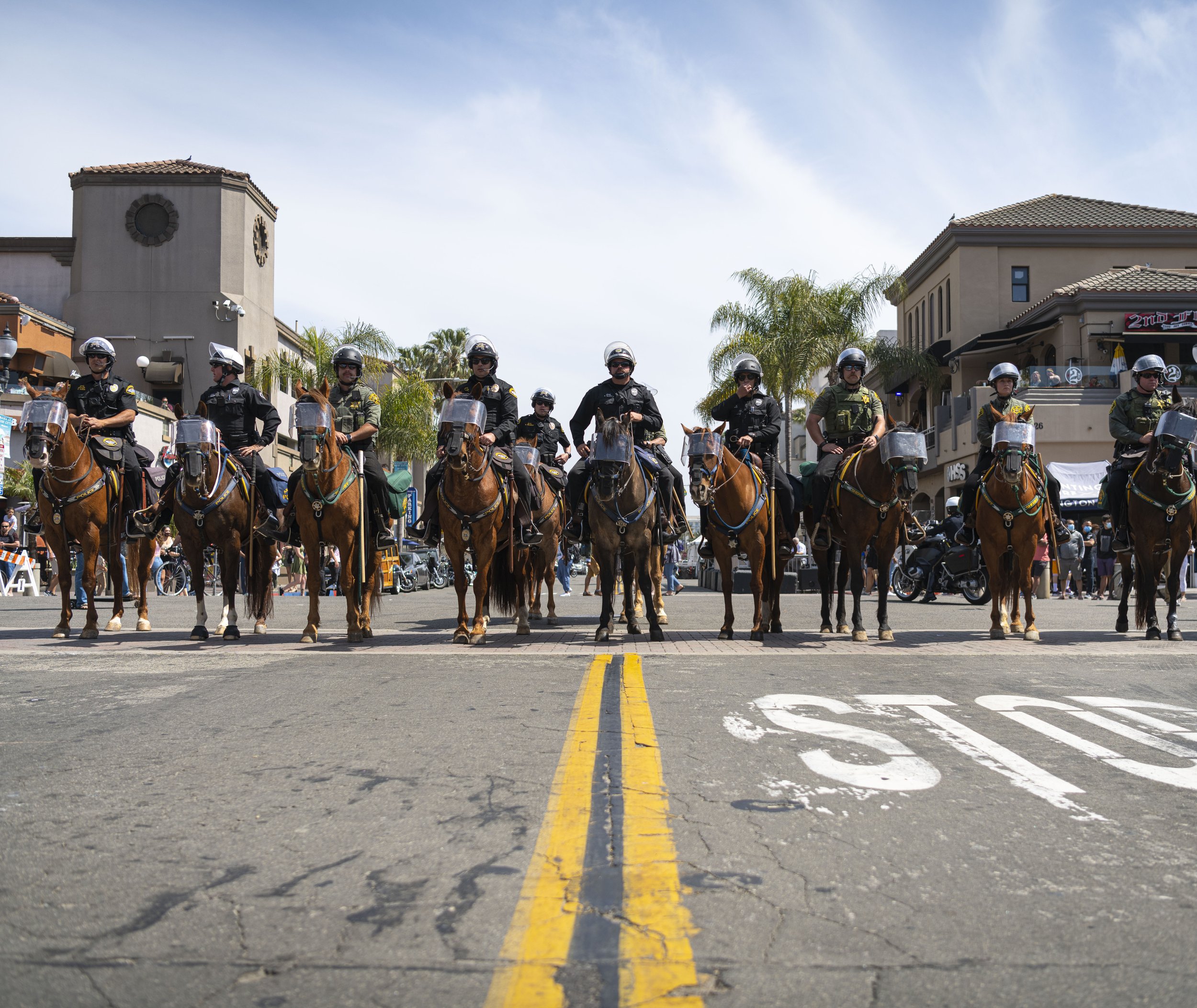  Huntington Beach Police officers assemble to dispurse the angry crowds at the Black Lives Matter/ White Lives Matter protest held in Huntington Beach Calif. on March 11, 2021. 
