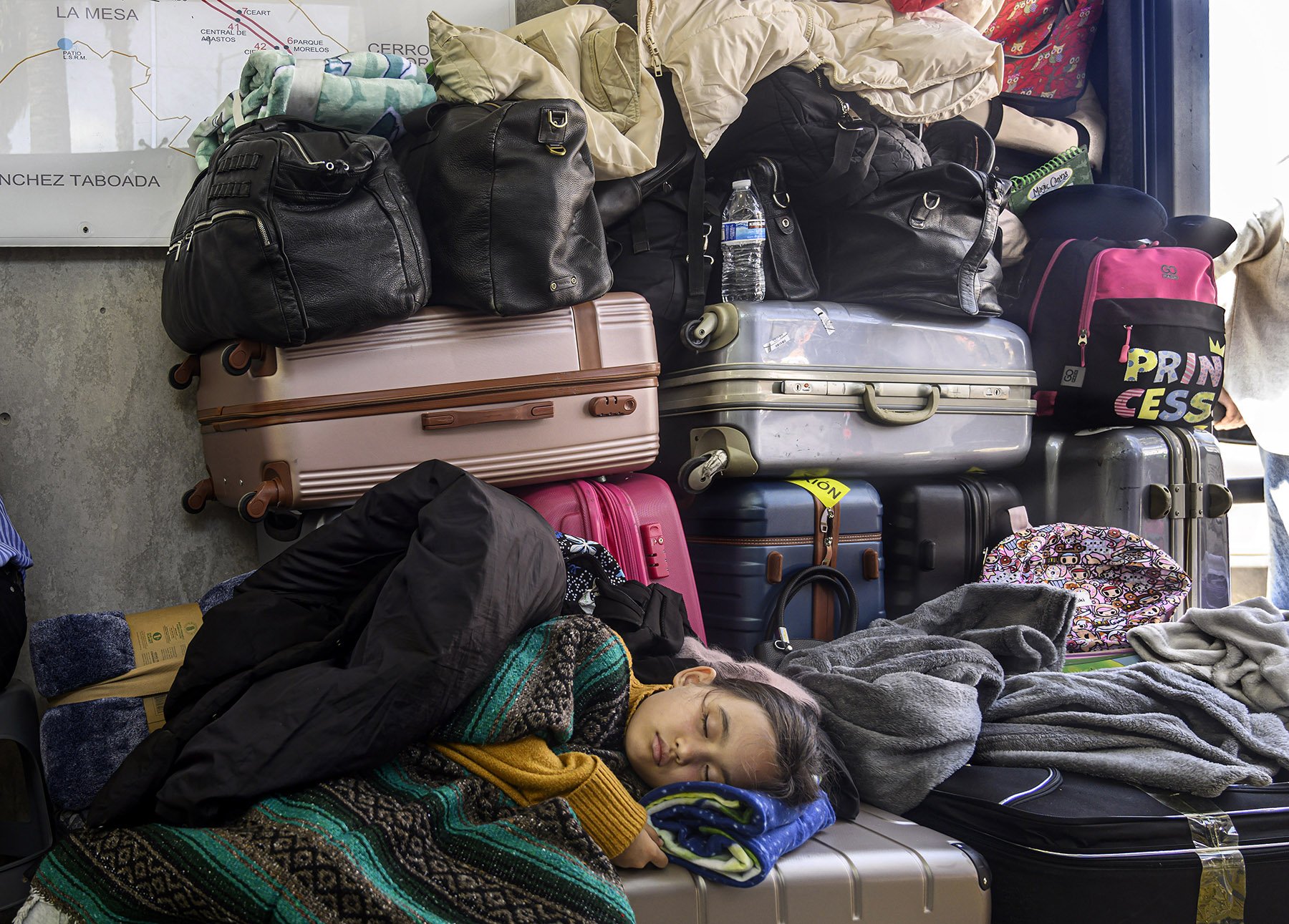 Exhausted Ukrainian families arrive in Tijuana on Wednesday, March 30, 2022. Many of them have traveled about a month to reach the Mexican border and will have to wait sometimes more than 24 hours before they are processed through the U.S. as asylum