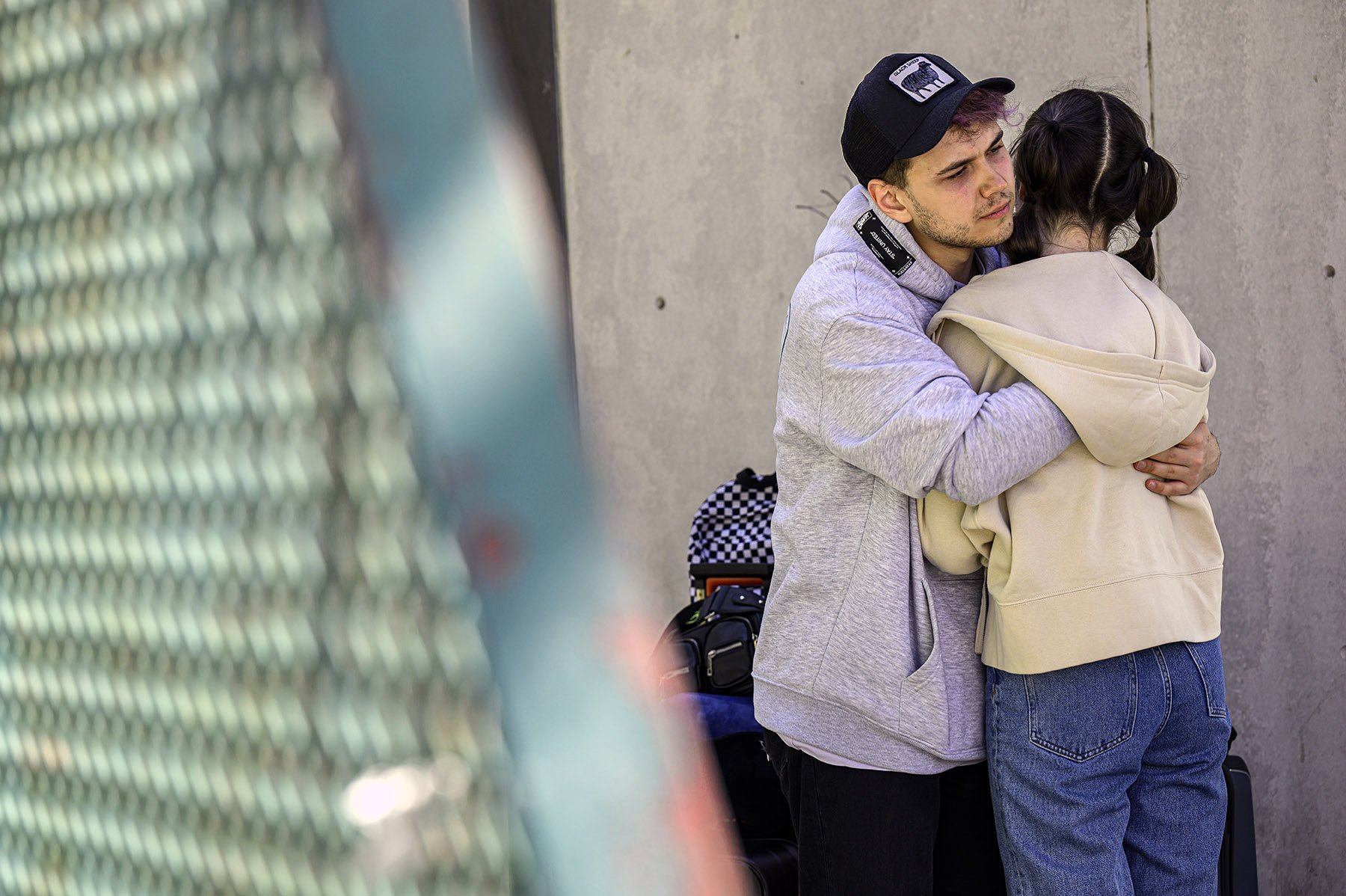  Anton Shchuz, 22, comforts his wife, Polina Shchuz, 20, at the Tijuana border on Wednesday, March 30, 2022. Polina, who is Russian, fears she will not be allowed into the U.S. with her Ukrainian husband. After Russia invaded Ukraine, the U.S. agreed
