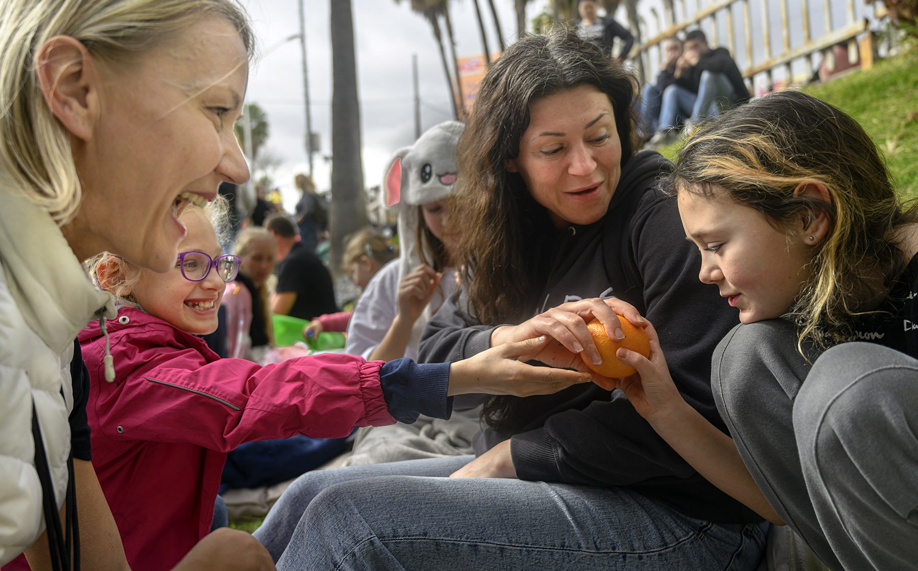  Rancho Mission Viejo resident and member of a Russian-speaking group of OC moms, Inna Levien, left, tries to brighten the birthday of Ukrainian refugee Karokina Melnychuk, right, who turned 10 in Tijuana. She and her family, including her mom, Marin