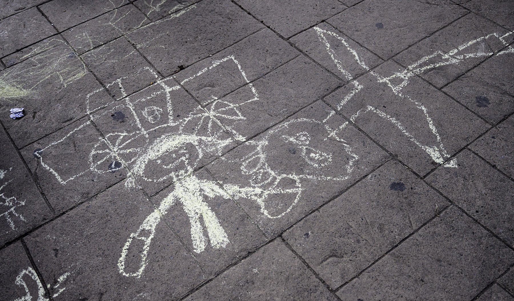  Ukrainian children waiting in Tijuana with their families while seeking asylum in the U.S., are given chalk by volunteers to help occupy the hours-long wait on Wednesday, March 30, 2022.  