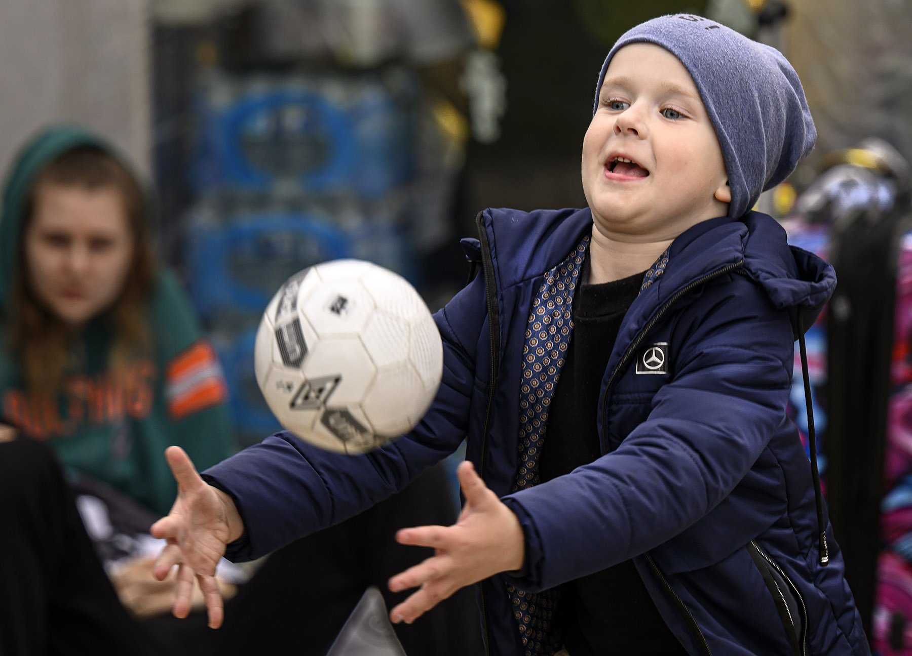  A Ukrainian boy plays catch with his mother while awaiting entry into the U.S. as asylum seekers on Wednesday, March 30, 2022. 