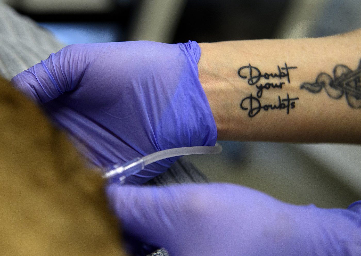  Vet tech Lauren Genger wears her philosophy on her wrist as she works on an animal at Serrano Animal Hospital in Lake Forest on Monday, March 1, 2021.  