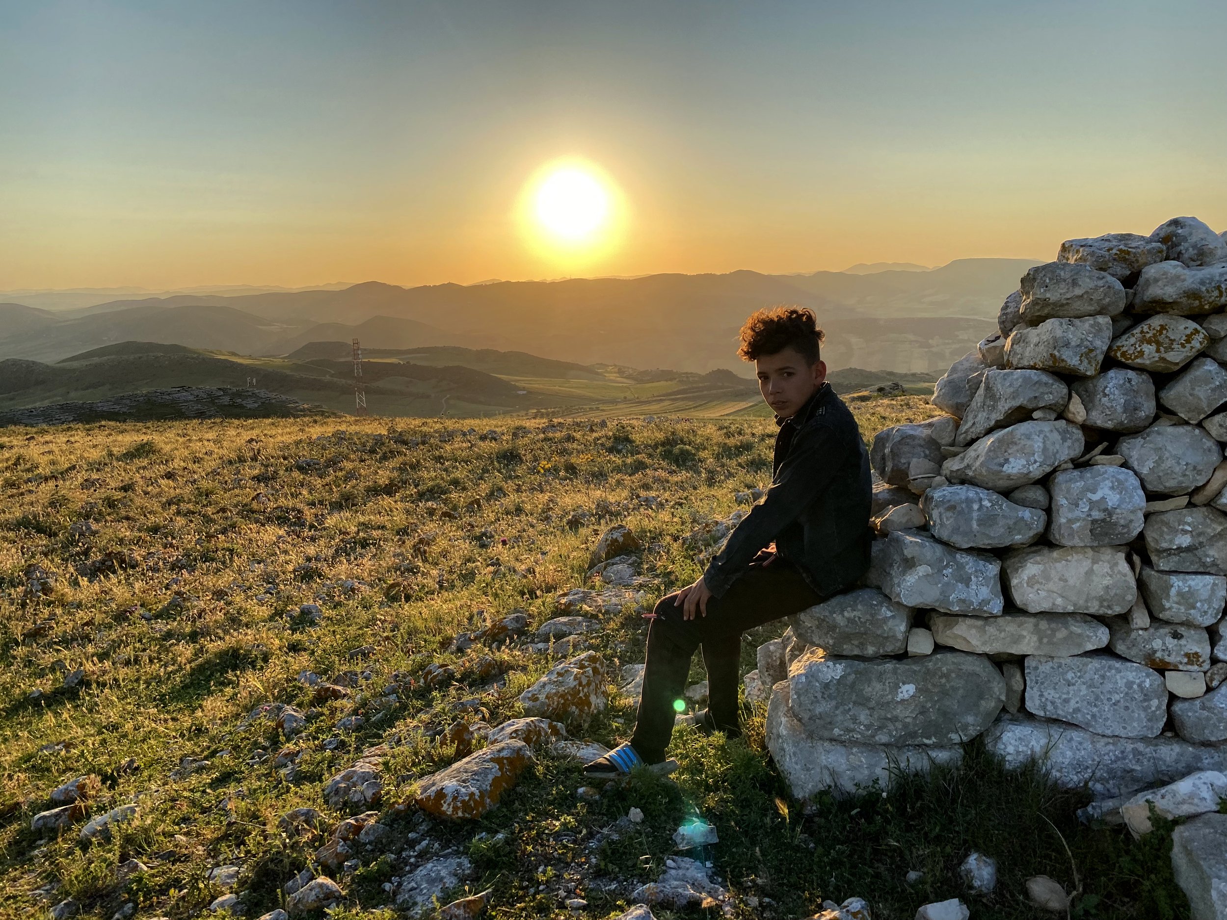  Sabri, a 14-year old village boy, sits on Roman era ruins that overlooks the approach US forces led by tanks took to assault Nazi forces occupying the critical Hill 609. The Americans suffered 2,453 casualties during the battle that lasted between 2