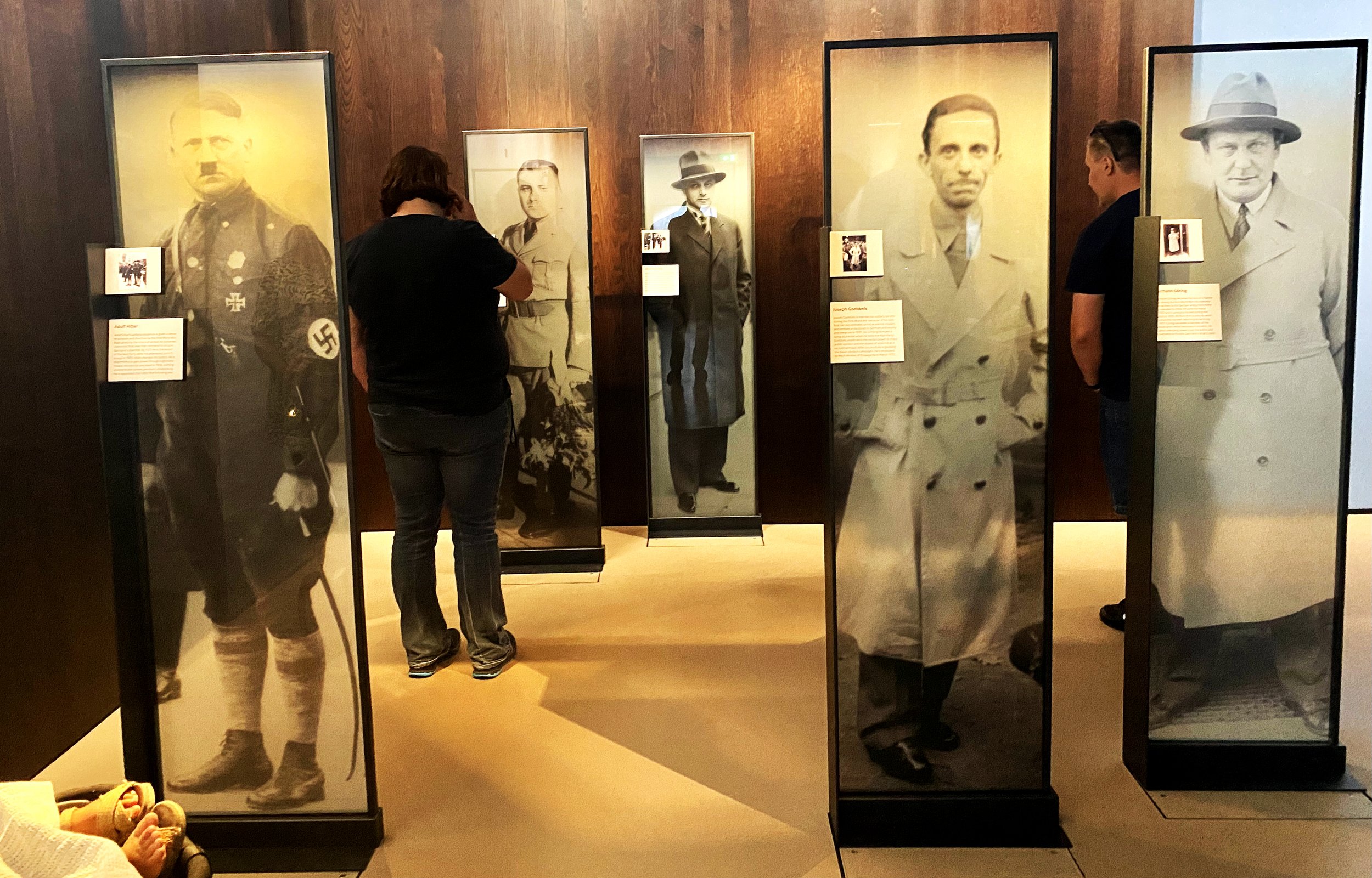  Visitors view an exhibit displaying life-size images of the Nazi leadership at the Imperial War Museum.  My father was an avid historian and was an OSS operative in World War II. 