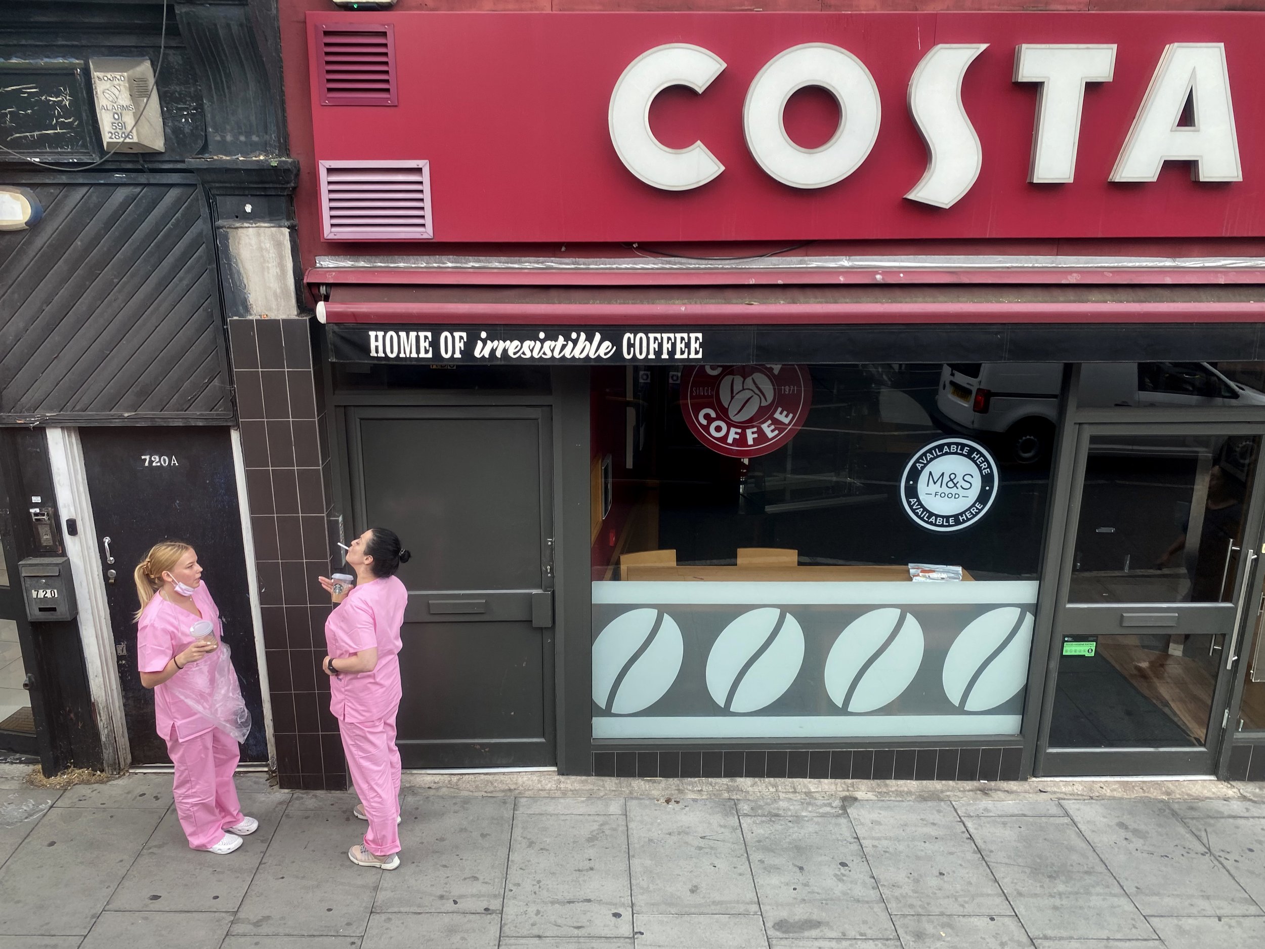  Manicurists enjoy a cigarette and coffee break on Holloway Road.  As with my parents who often road the double decker buses, I would hop on one and see where it took me. 