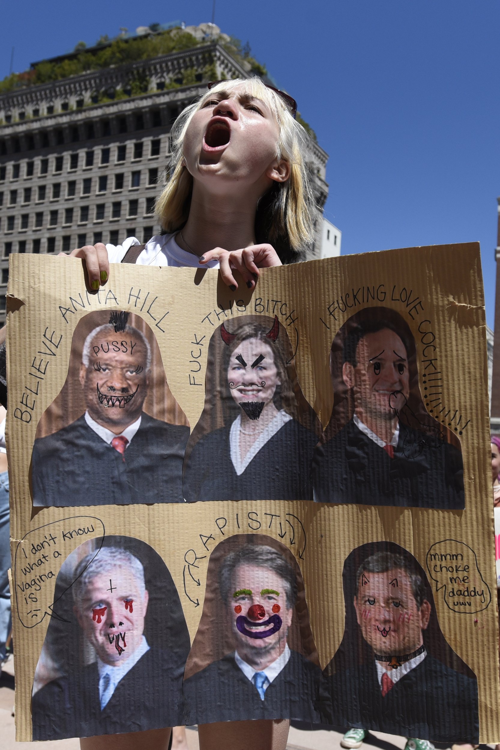  A young woman protests the decision with a handmade sign. 