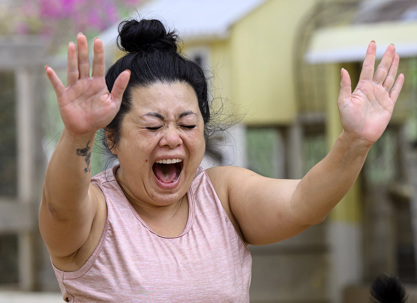  Jennie Rios of Irvine reacts after baby goat Violet had a potty accident on her back and it seeped “to my buttocks,” during Yin Yoga at Goods and Goats in San Juan Capistrano on Sunday, August 28, 2022.  