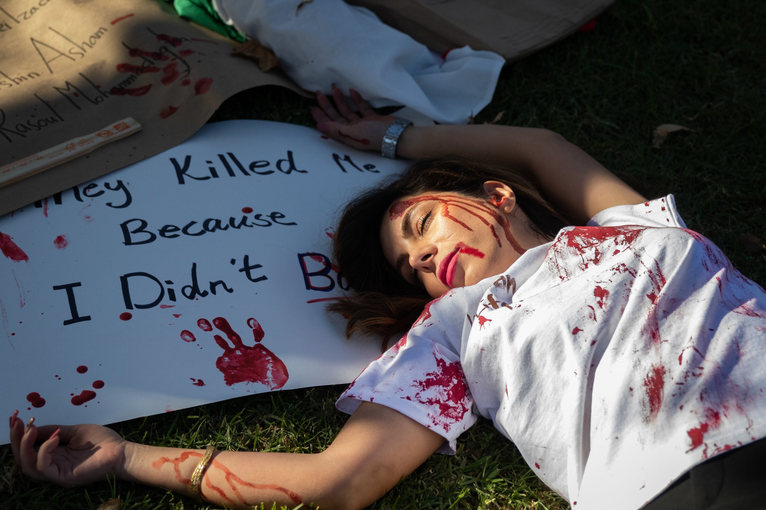  Bahar Khosropour performing a die-in in honor of those murdered and imprisoned in Iran. This performance was during the Freedom for Iran human chain in Glendale, Calif., on Saturday, Oct. 29, 2022, as part of a global action. (Caylo Seals | The Cors
