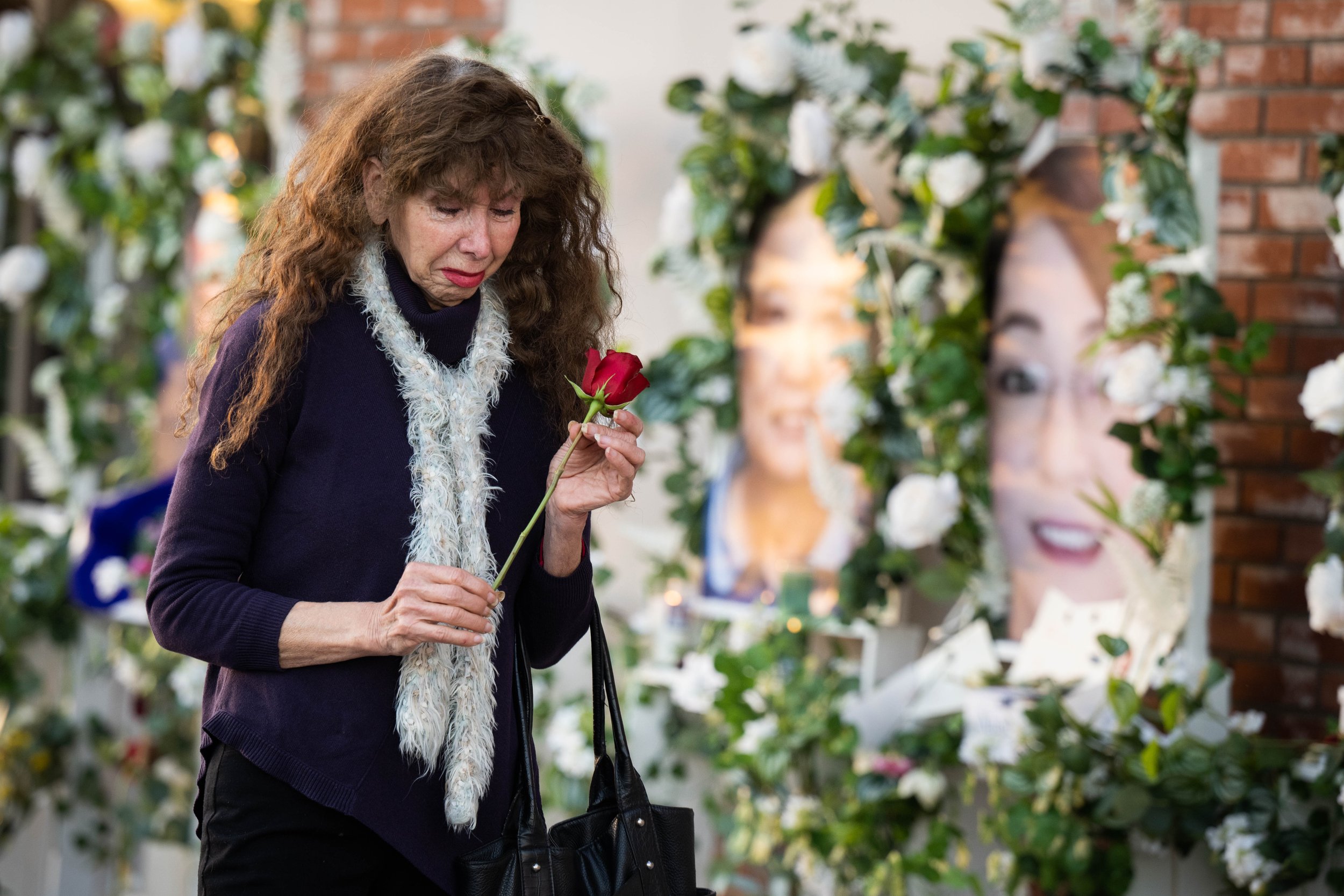  Dancer Adelle Castro, 68, of Temple City, left, visits on Thursday, January 26, 2023 the memorial for the victims of the Monterey Park mass shooting at Star Ballroom Dance Studio where 11 of her friends were killed. “They were my family for 30 years
