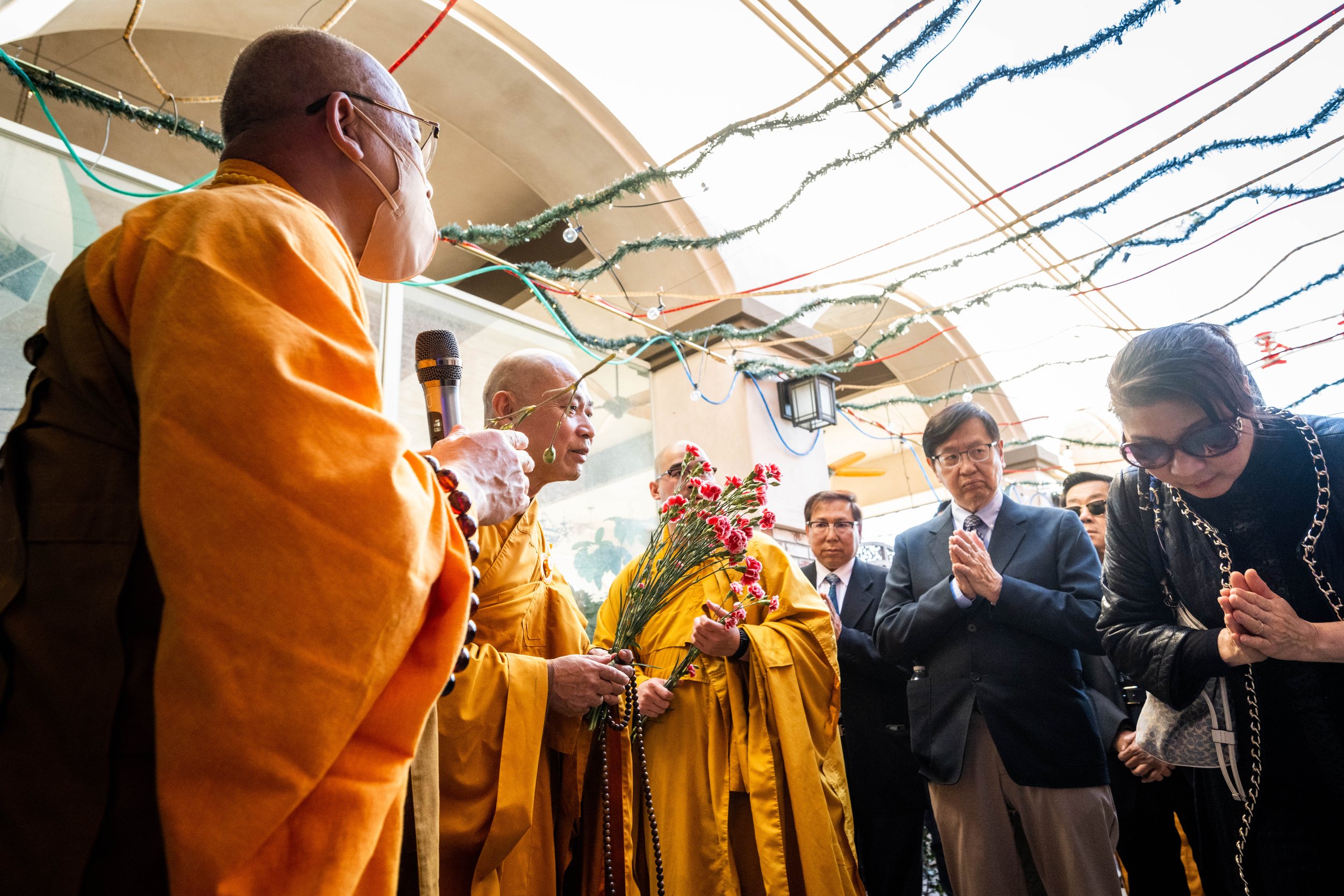  Dieu Phap Temple monks hold a service for those killed in the Monterey Park mass shooting at Star Ballroom Dance Studio with owner Maria Liang, right, on Friday, January 27, 2023.  