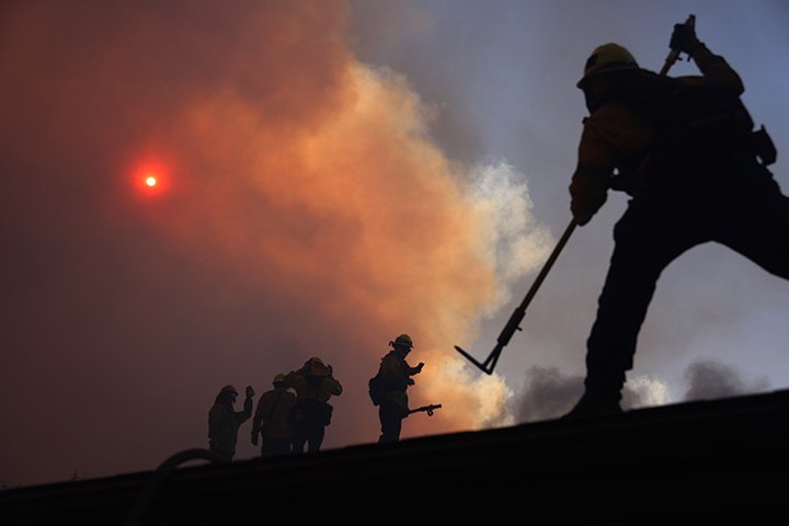  Los Angeles Fire Department personnel work a house fire at the start of the Palisades Fire January 7th, 2025. 