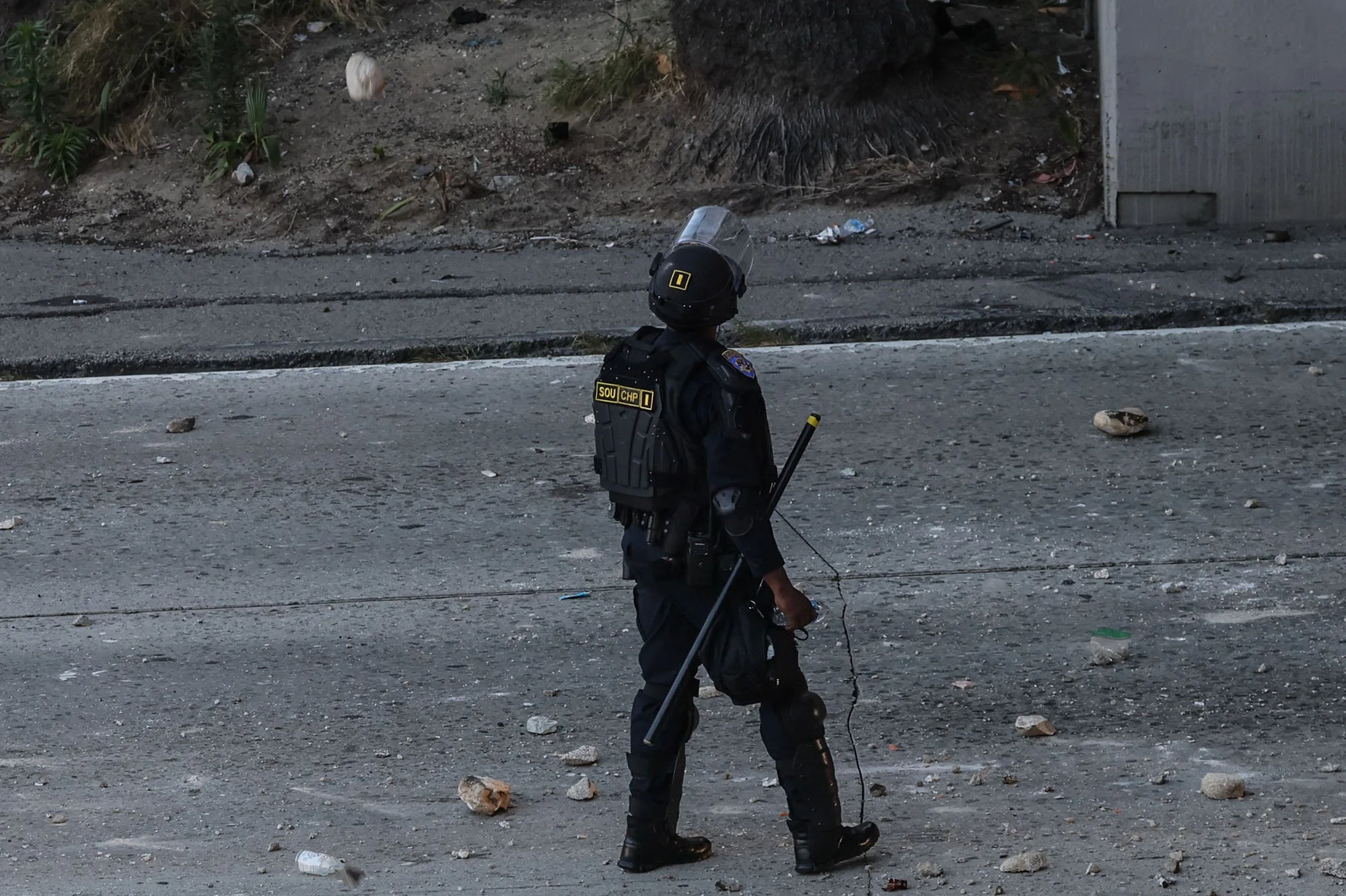  Los Angeles, CA, Sunday, June 8, 2025 - Protesters throw rocks from Aliso St. at CHP officers stationed on the 101 fwy below. This rock was a near miss. 