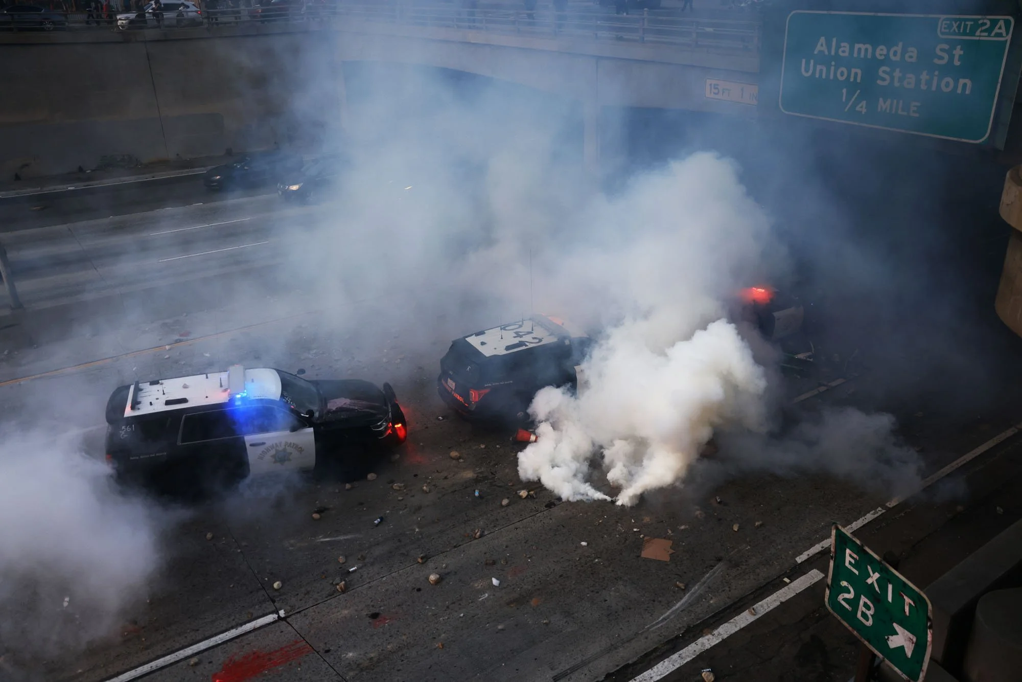  Los Angeles Police vehicles sit pelted with rocks and debris during a protest against federal immigration sweeps, in downtown Los Angeles, California. 