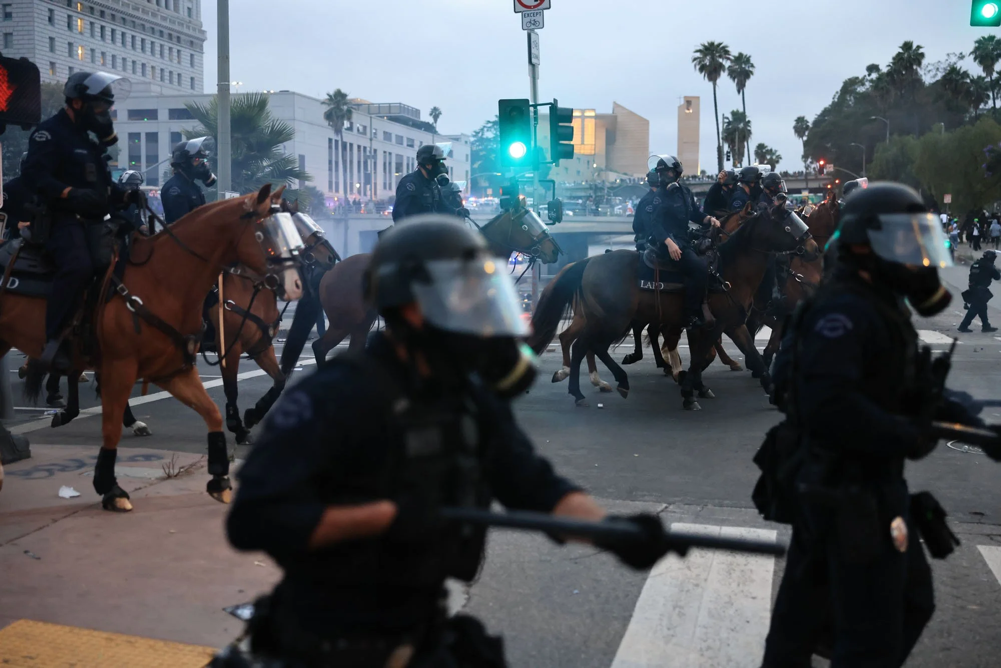  Mounted police and office charge forward toward protesters during a protest against federal immigration sweeps, in downtown Los Angeles, California. 