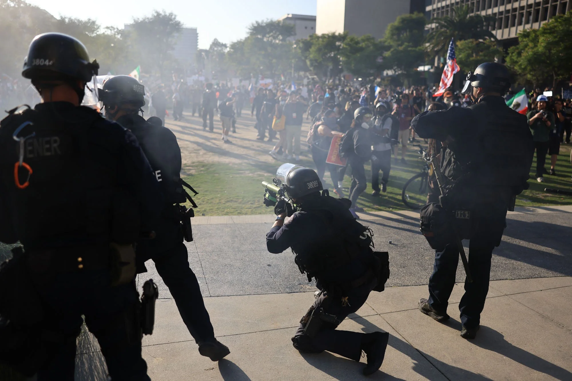  A Los Angeles Policeman takes aim during a protest against federal immigration sweeps, in downtown Los Angeles, California. 