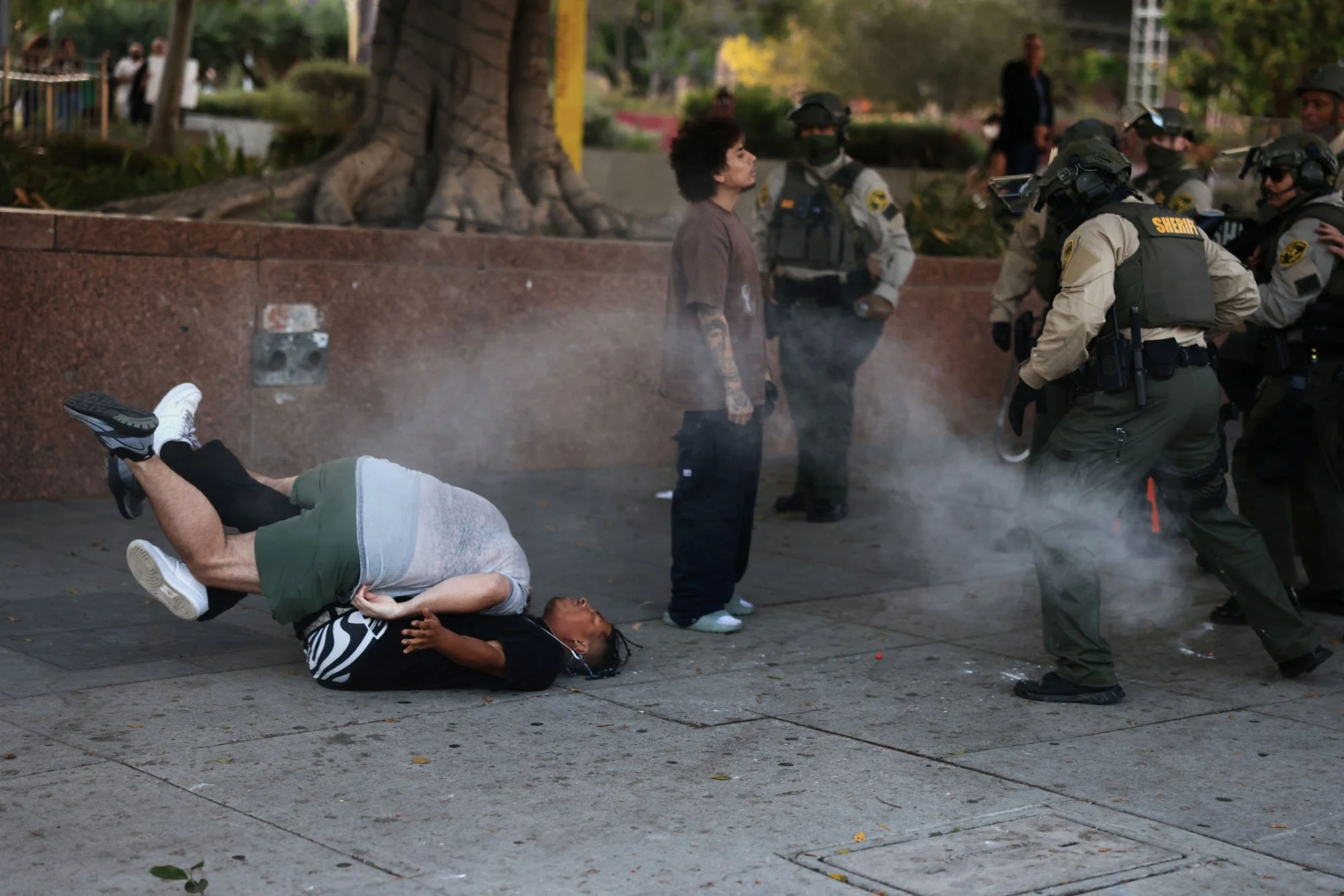  A man that was shot is tackled by a man during a protest against federal immigration sweeps, in downtown Los Angeles, California. 